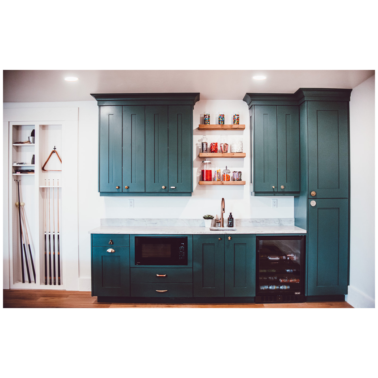 Bar with black microwave, recessed lighting, beverage cooler, a sink, and indoor wet bar