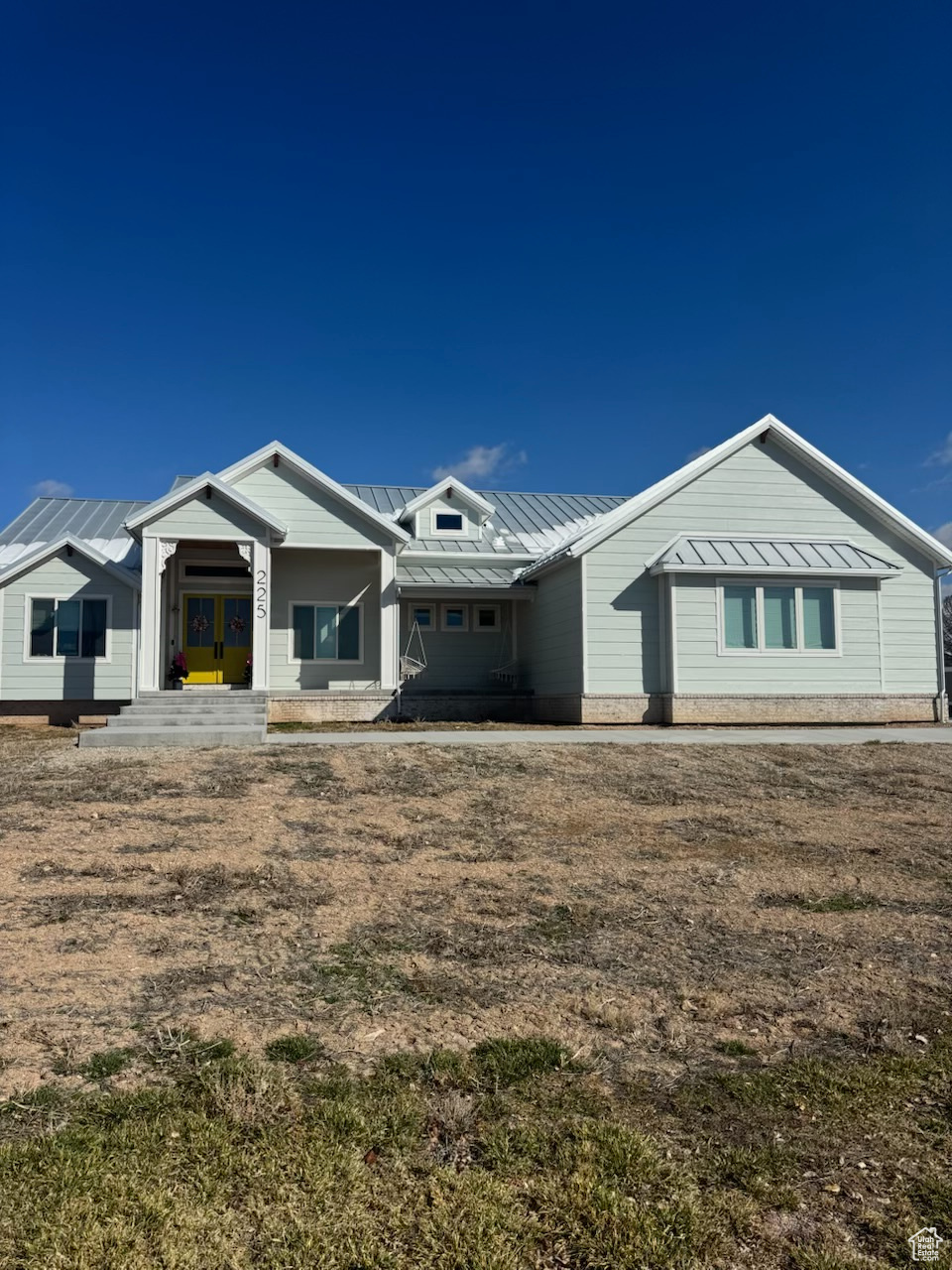 Rear view of property featuring a standing seam roof and metal roof