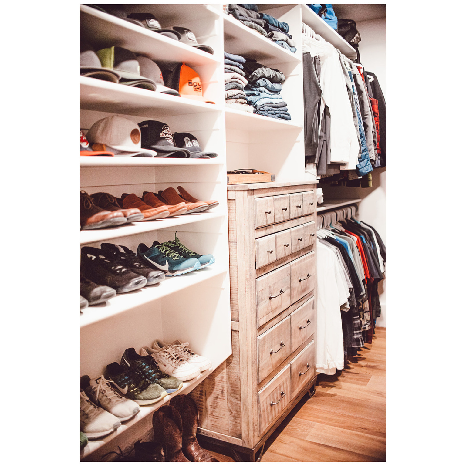 Walk in closet with light wood finished floors