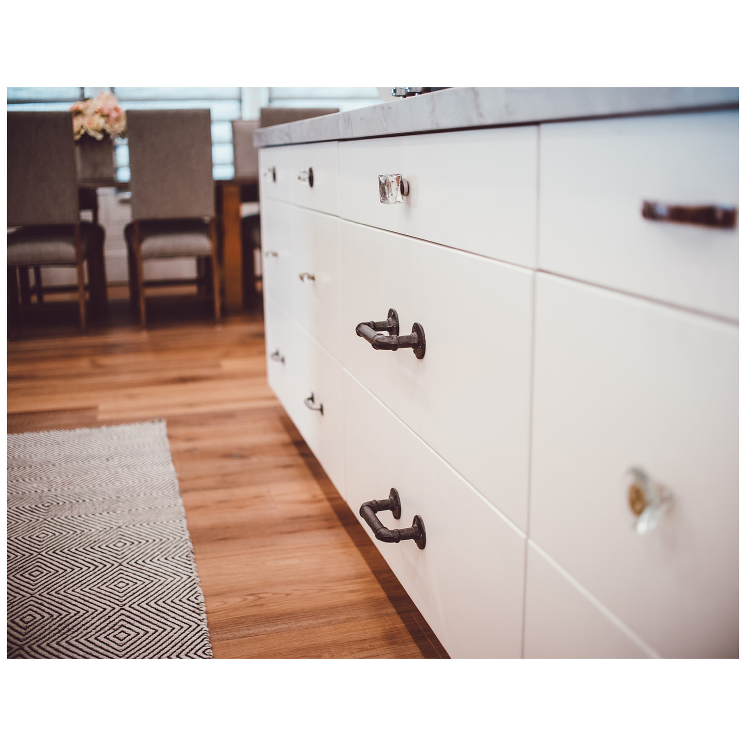 Room details featuring light wood-style flooring and white cabinets