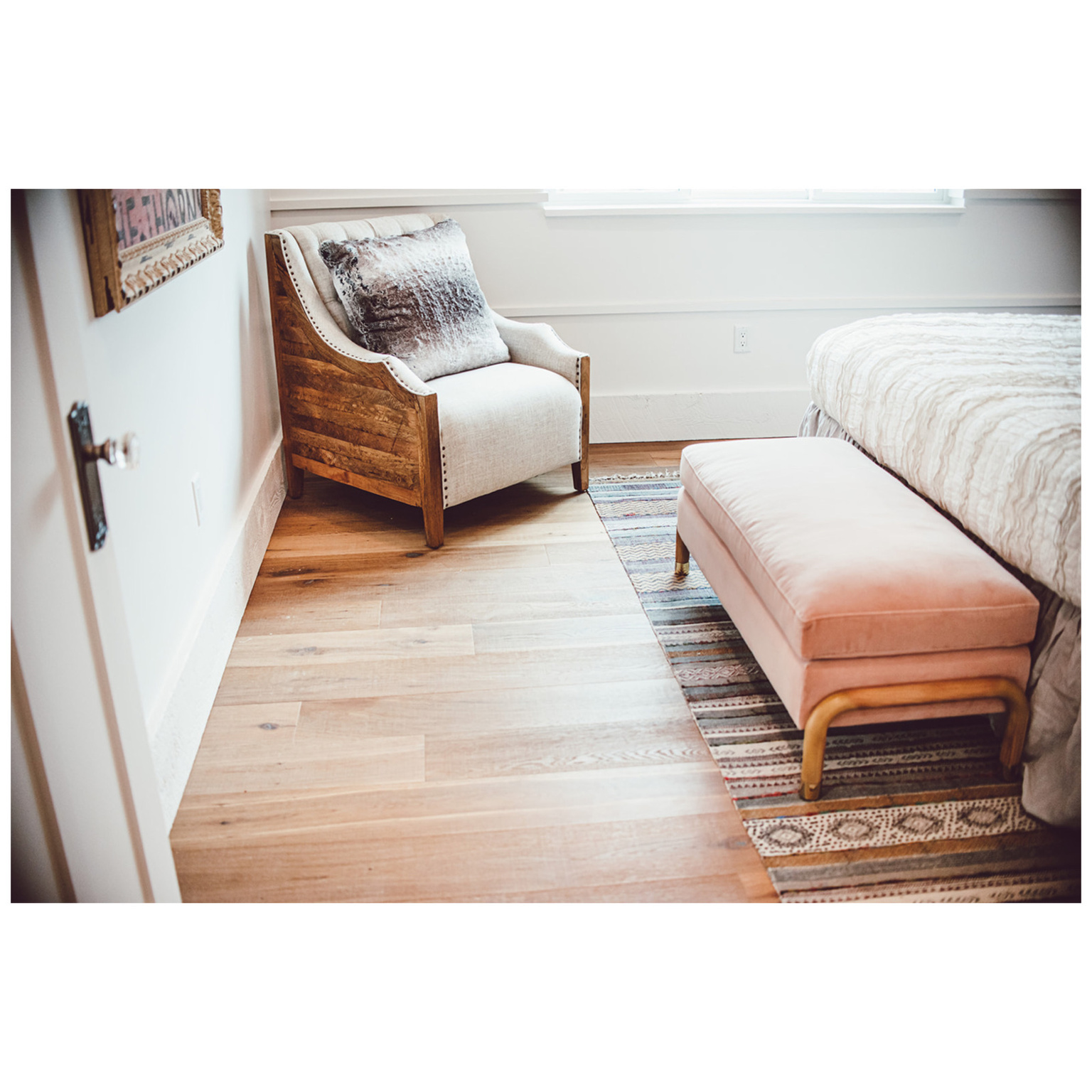 Bedroom with light wood finished floors and baseboards