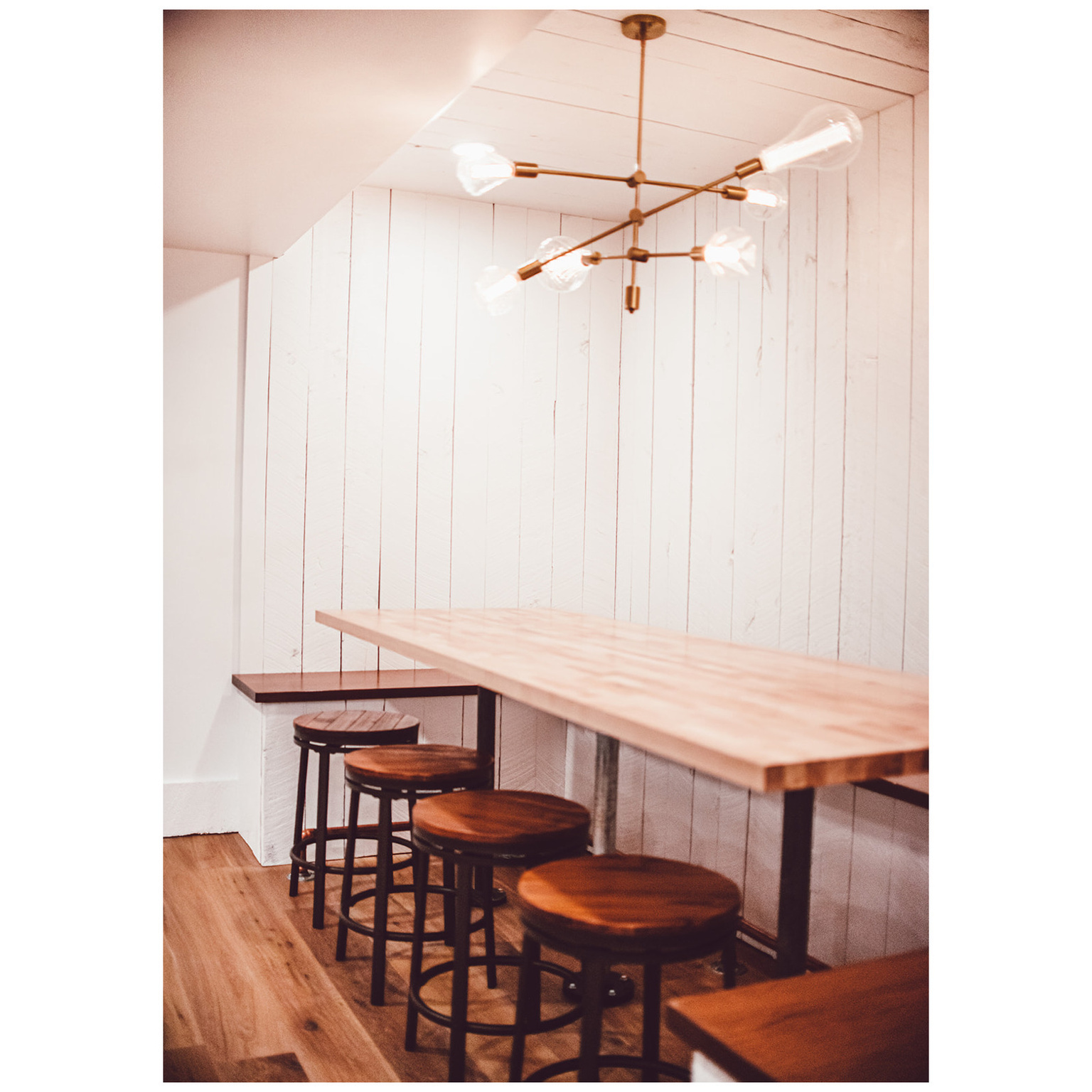 Dining space featuring wooden walls and wood finished floors