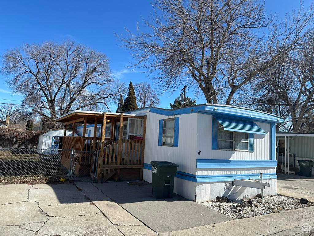 Manufactured / mobile home featuring an outbuilding, a storage shed, and fence