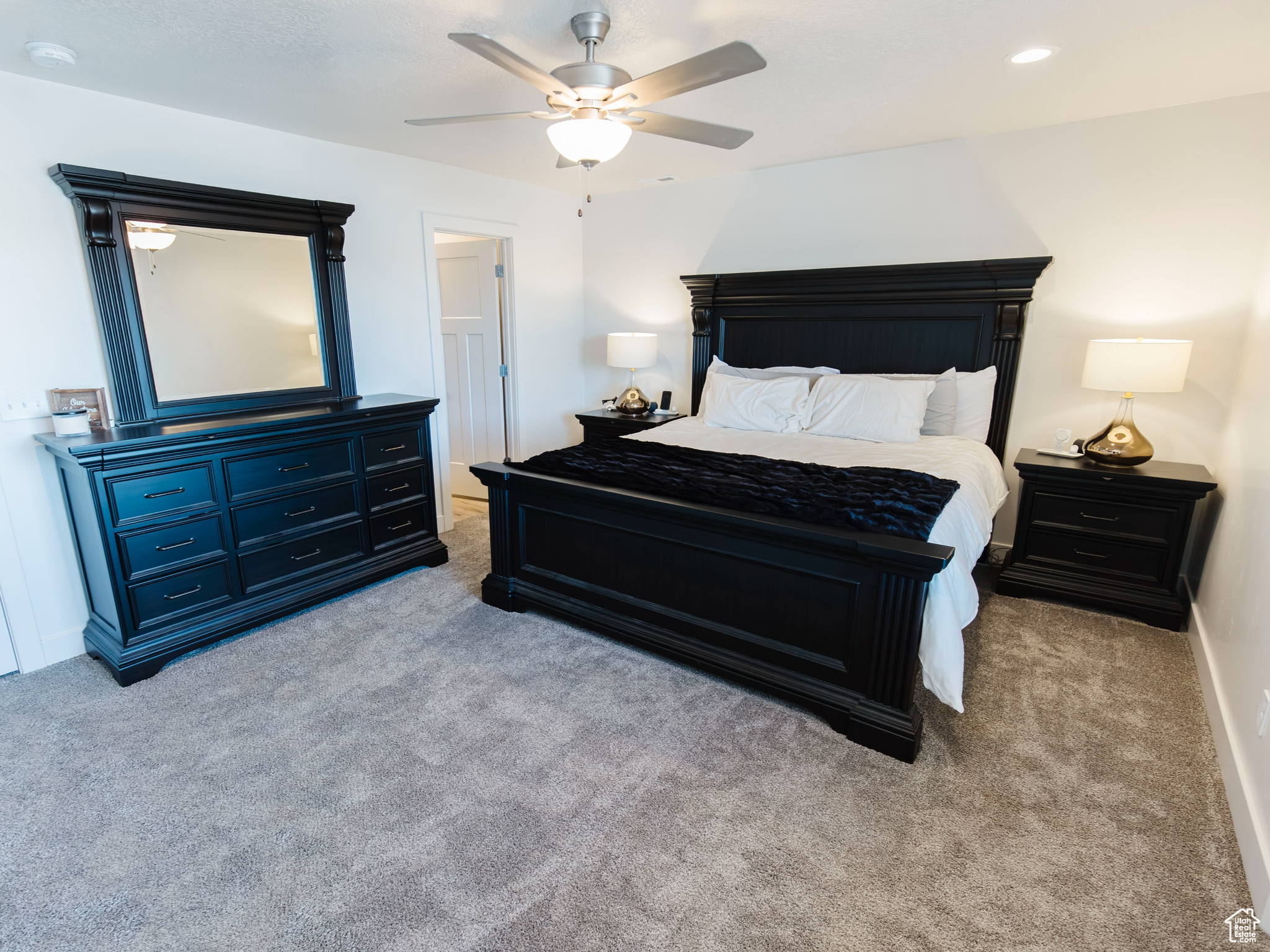 Carpeted bedroom with ceiling fan, baseboards, and recessed lighting