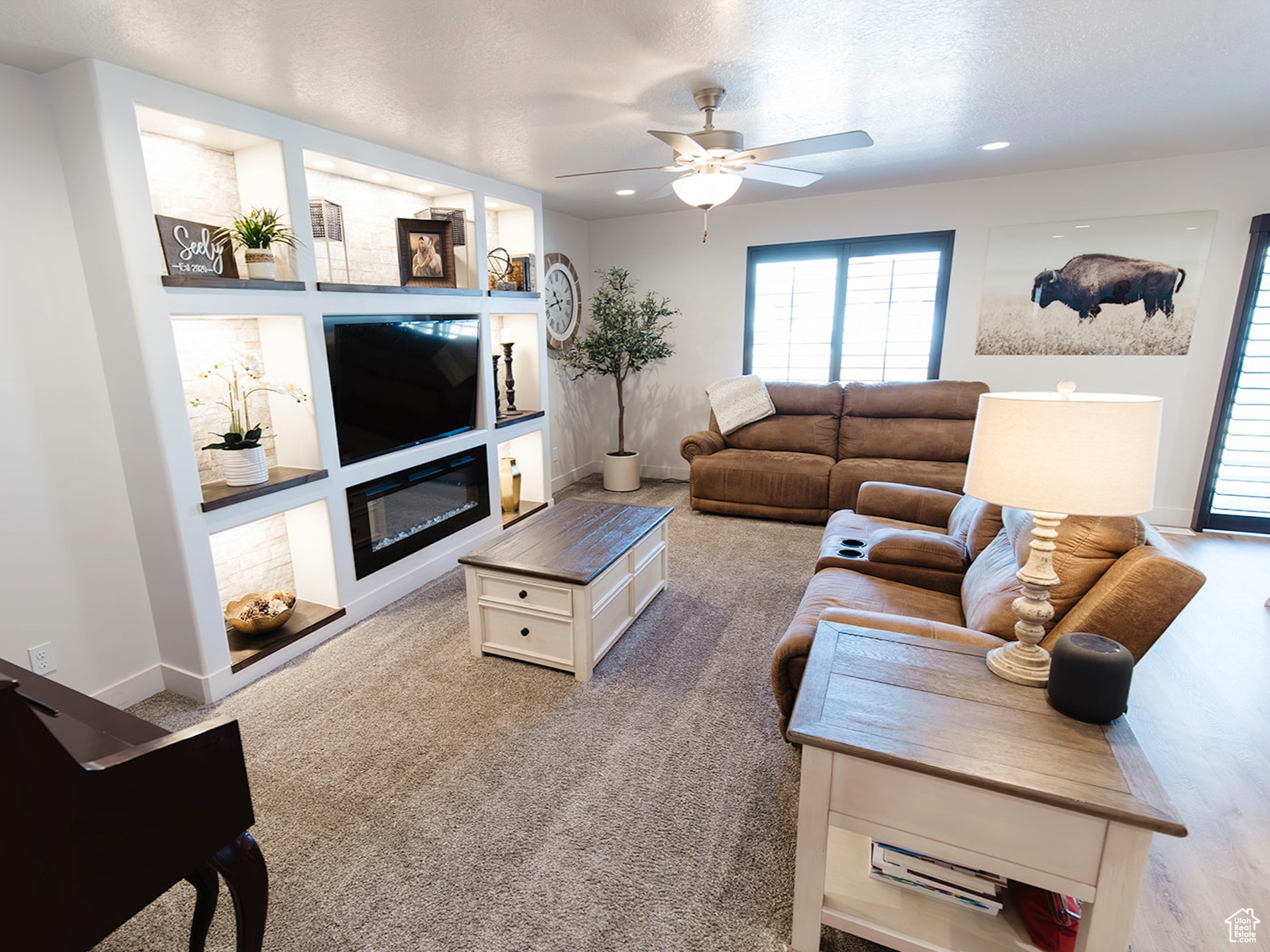 Living area with baseboards, a ceiling fan, a glass covered fireplace, carpet flooring, and recessed lighting