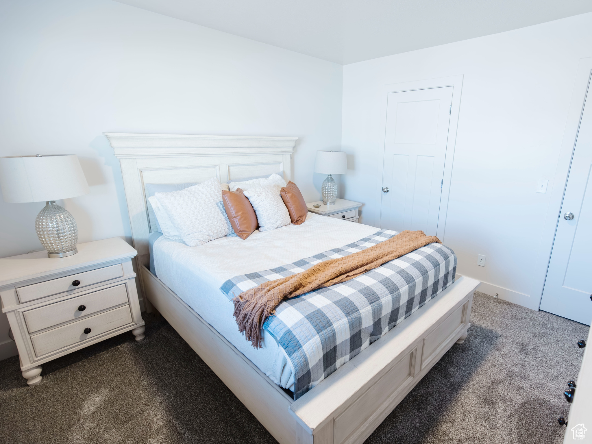 Bedroom with dark colored carpet