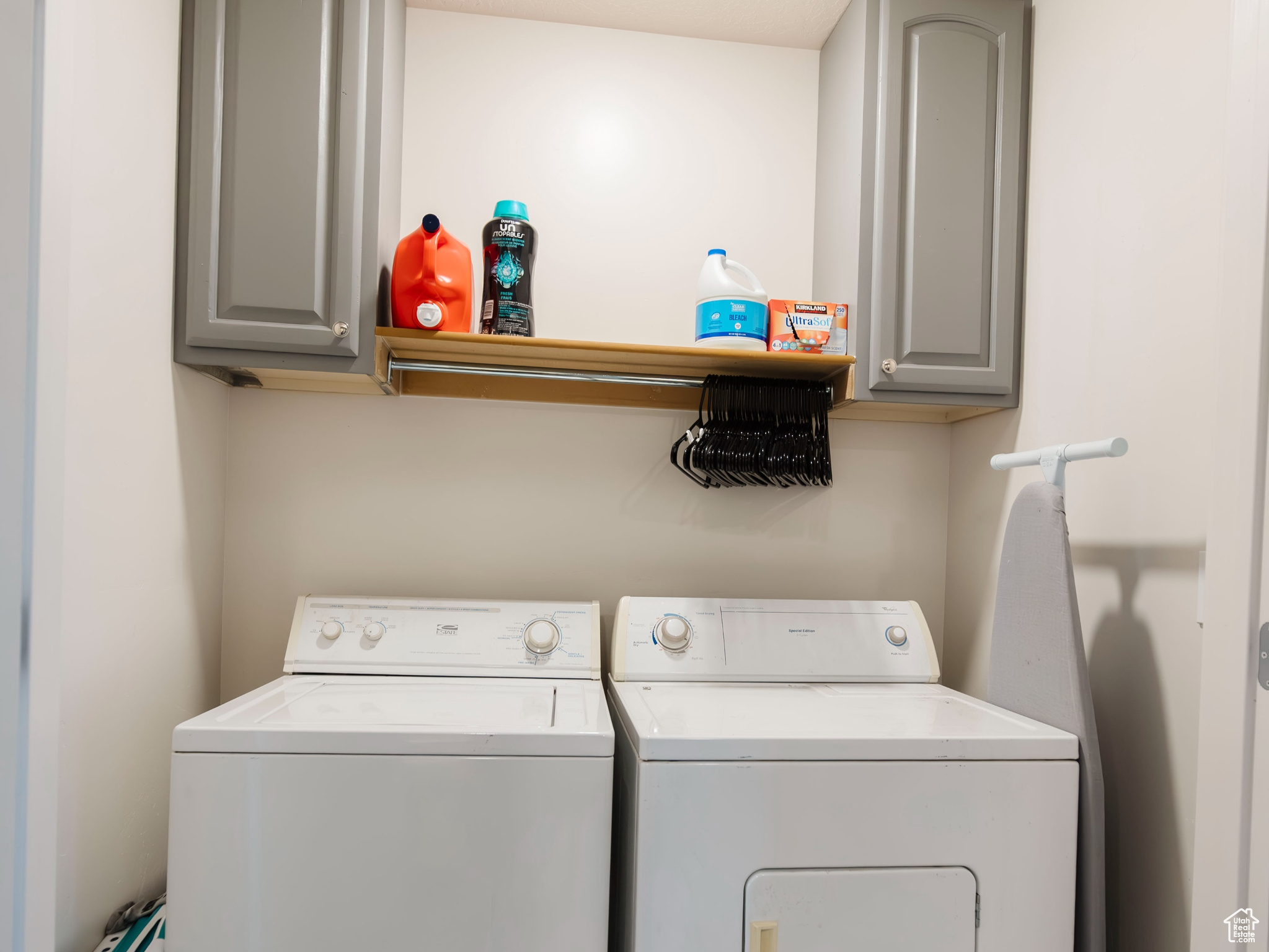 Laundry room featuring cabinet space, separate washer and dryer, and wood finished floors