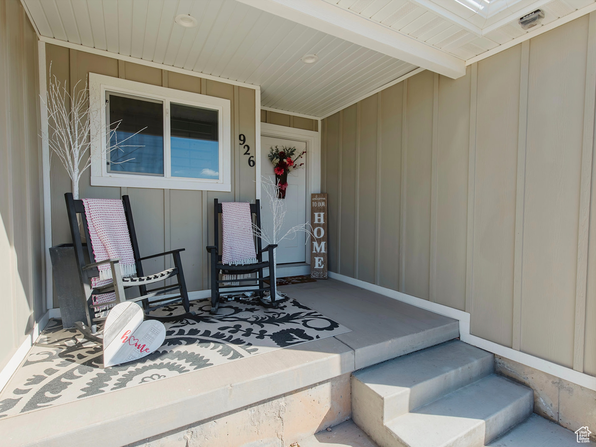 Property entrance featuring board and batten siding