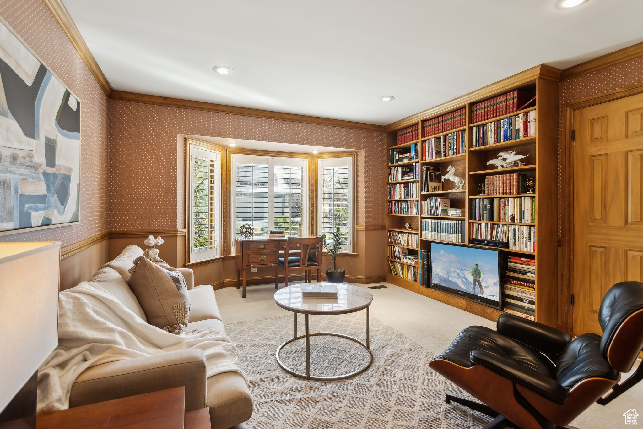 Built-in bookcase and large window looking out to front yard