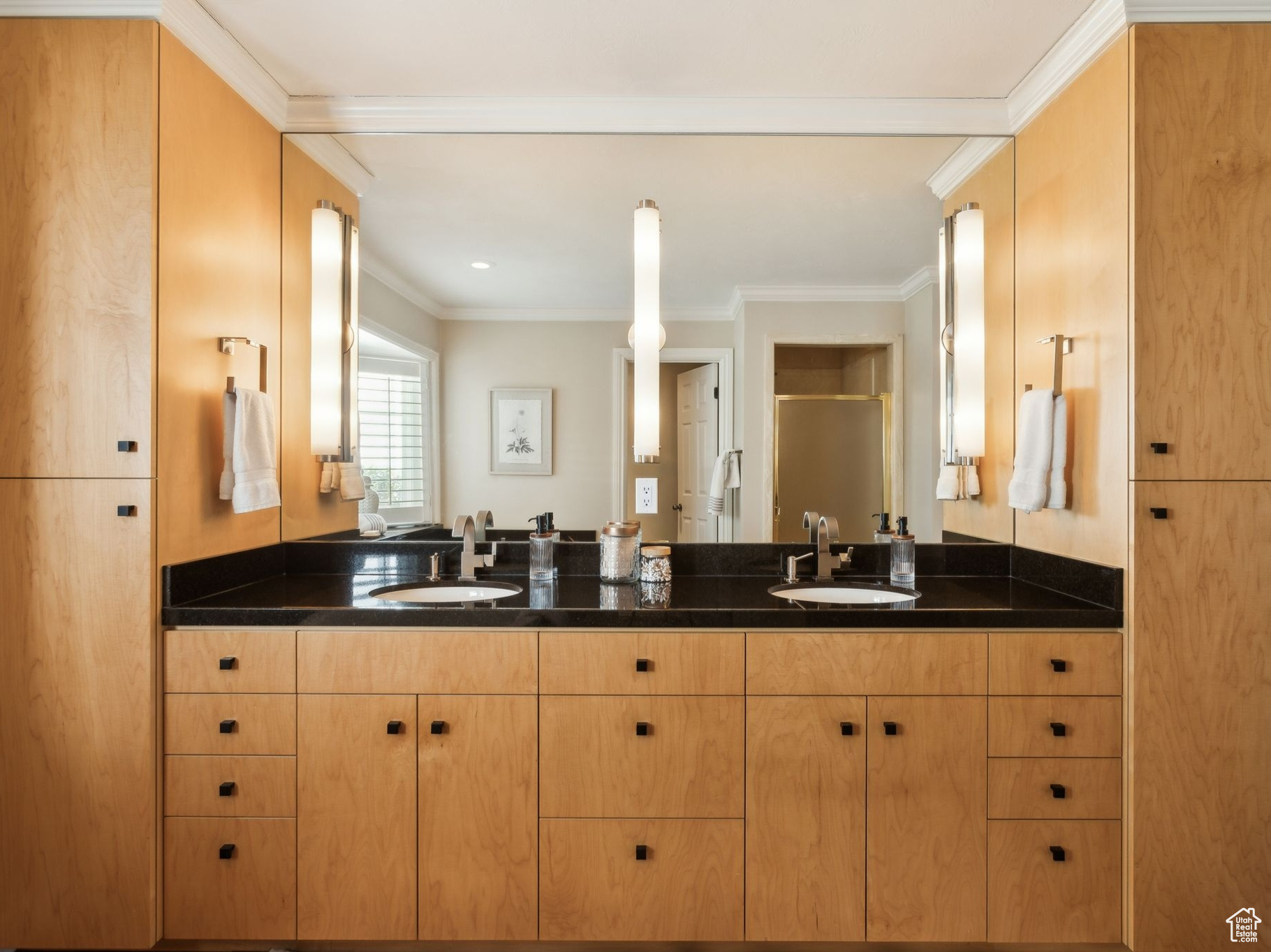 Custom cabinetry, honed black counter tops and two sinks