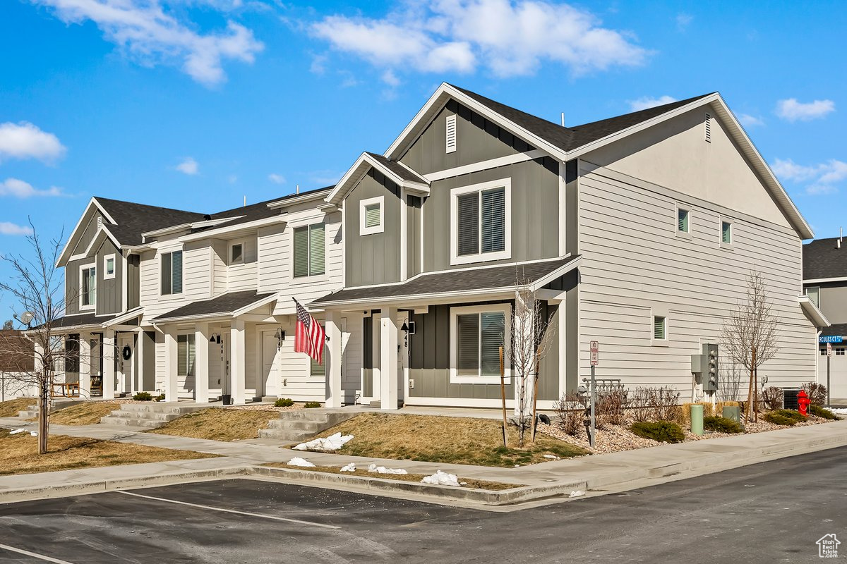 View of front of home featuring a residential view, board and batten siding, and uncovered parking