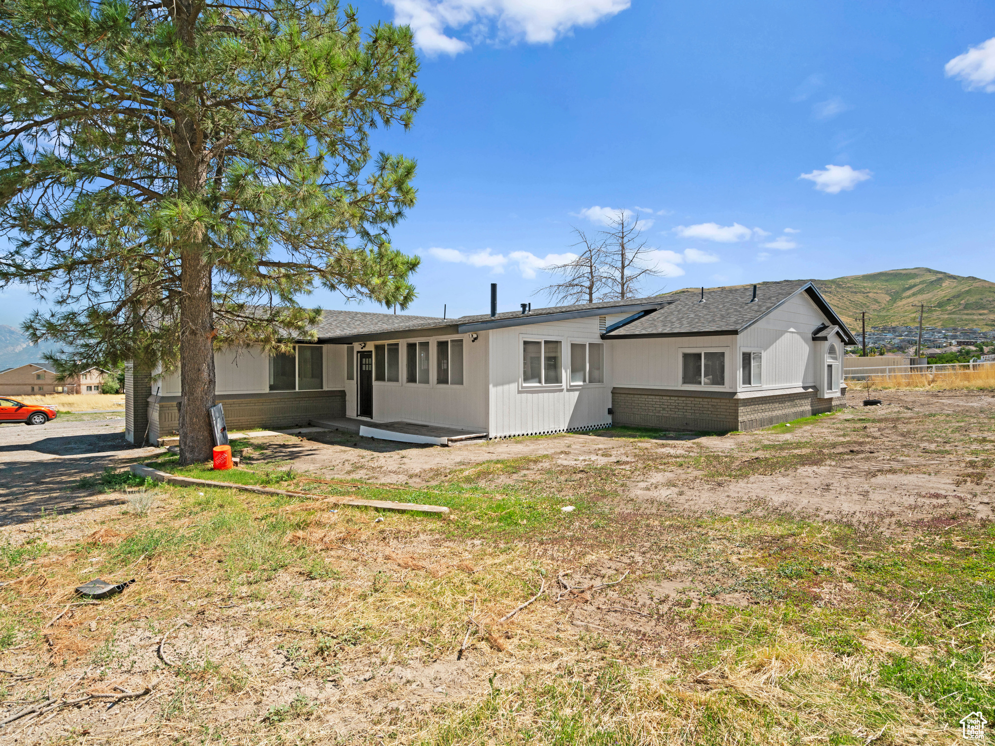 Rear view of house with a mountain view and brick siding