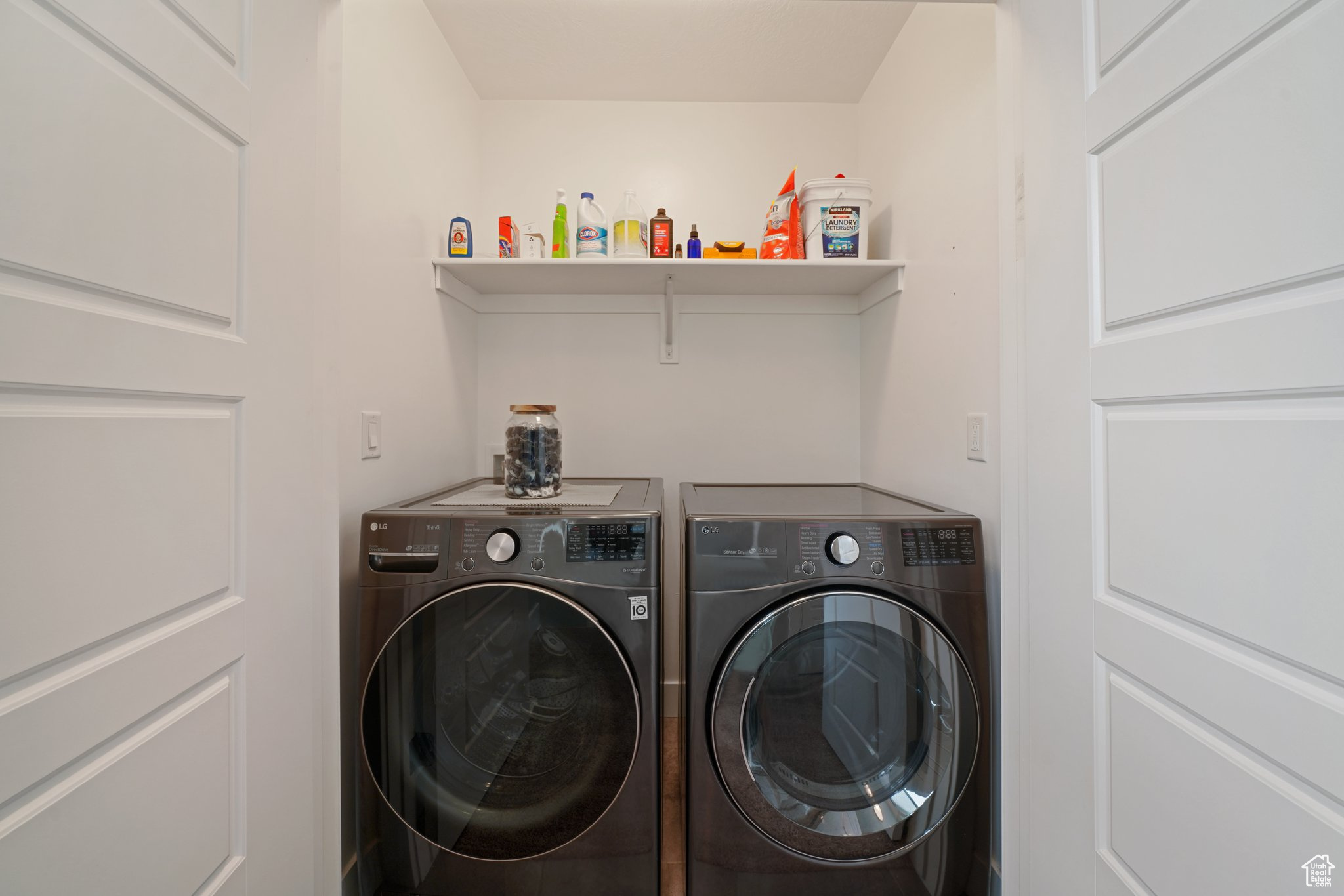 Washroom featuring separate washer and dryer and laundry area
