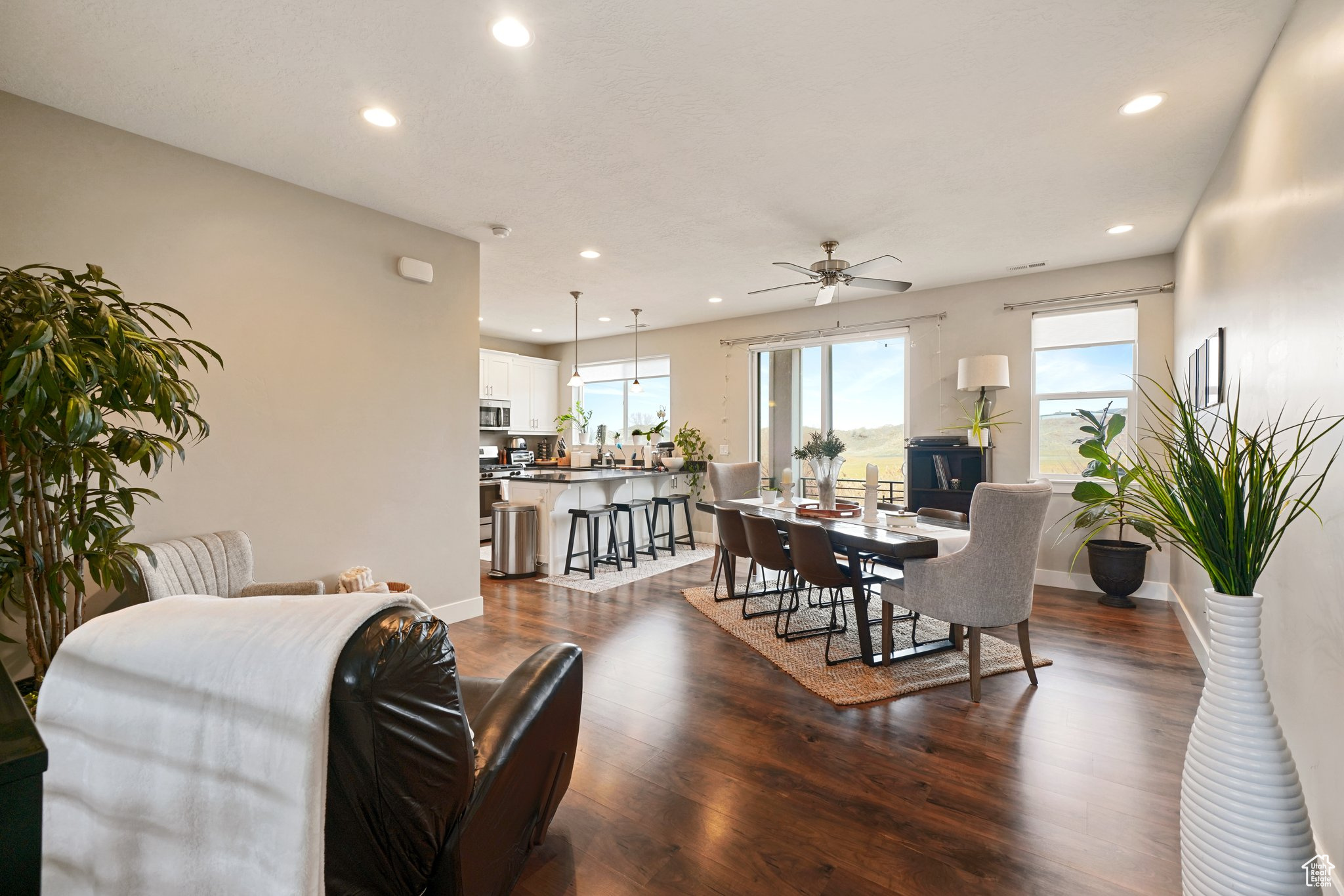 Dining room featuring recessed lighting, ceiling fan, baseboards, and dark wood-style flooring