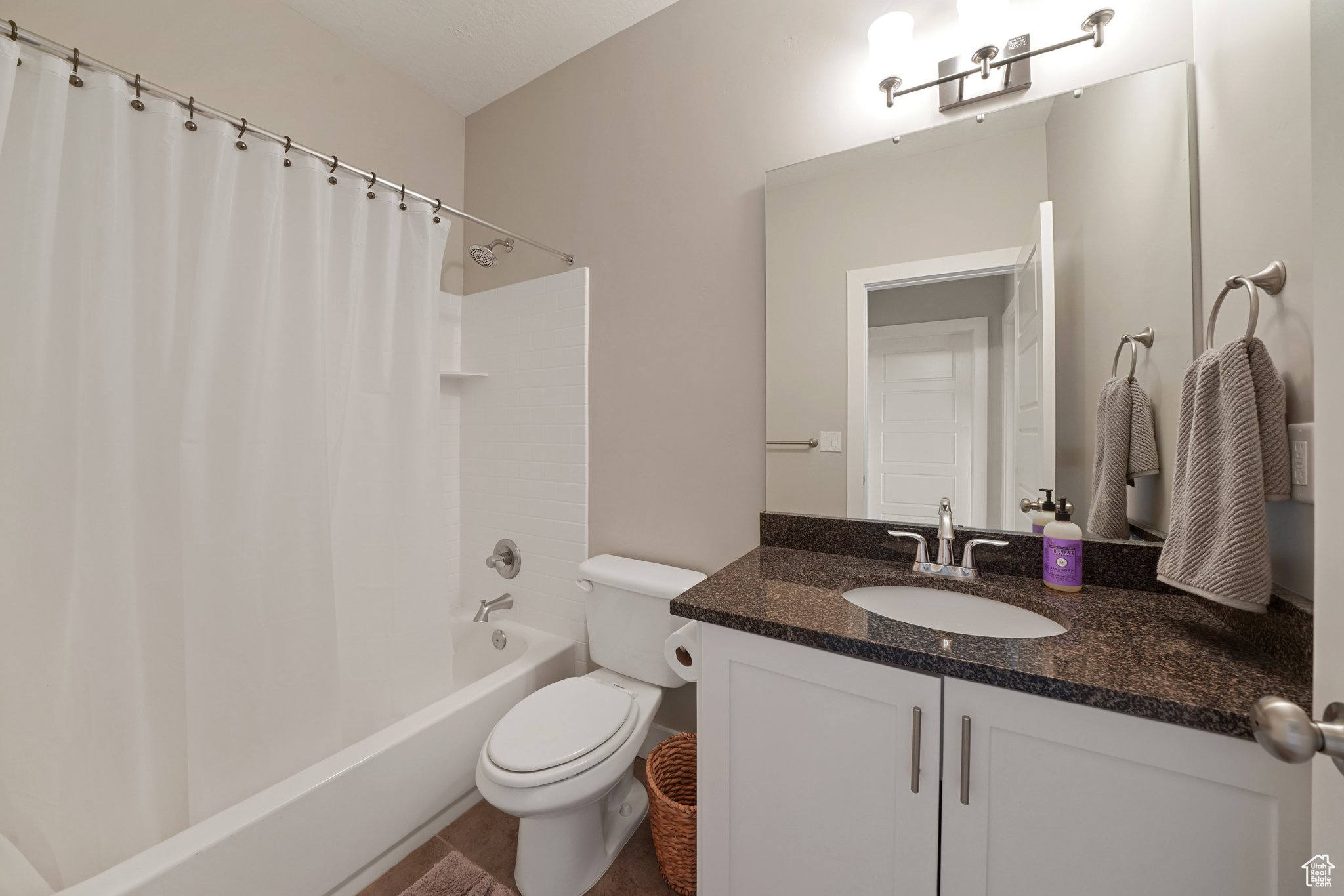 Full bath with shower / tub combo, toilet, and vanity