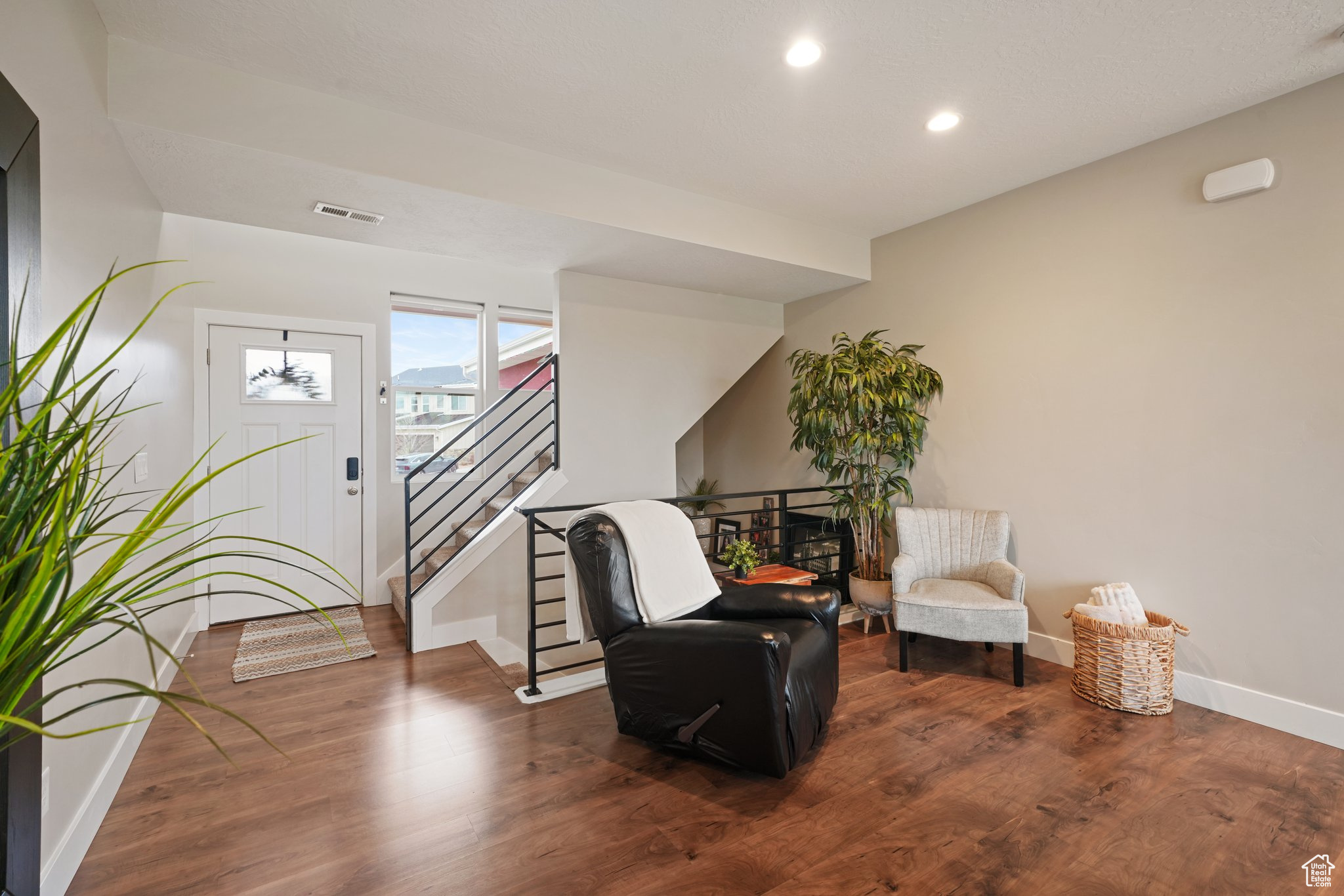 Sitting room with recessed lighting, stairway, baseboards, and wood finished floors