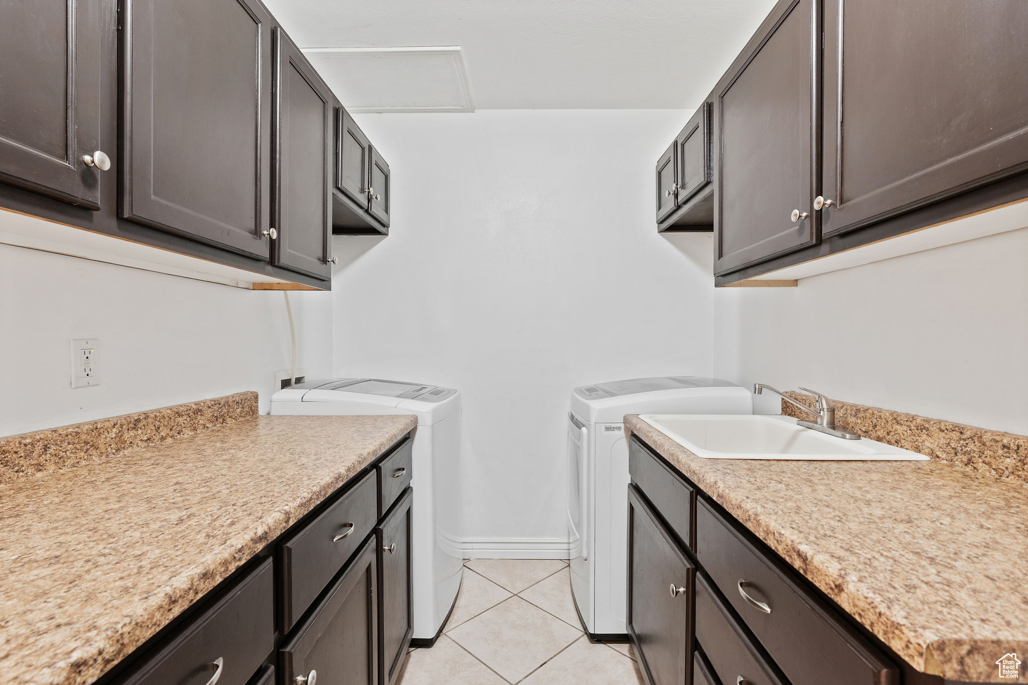 Laundry room, mud room, featuring cabinets and a sink.