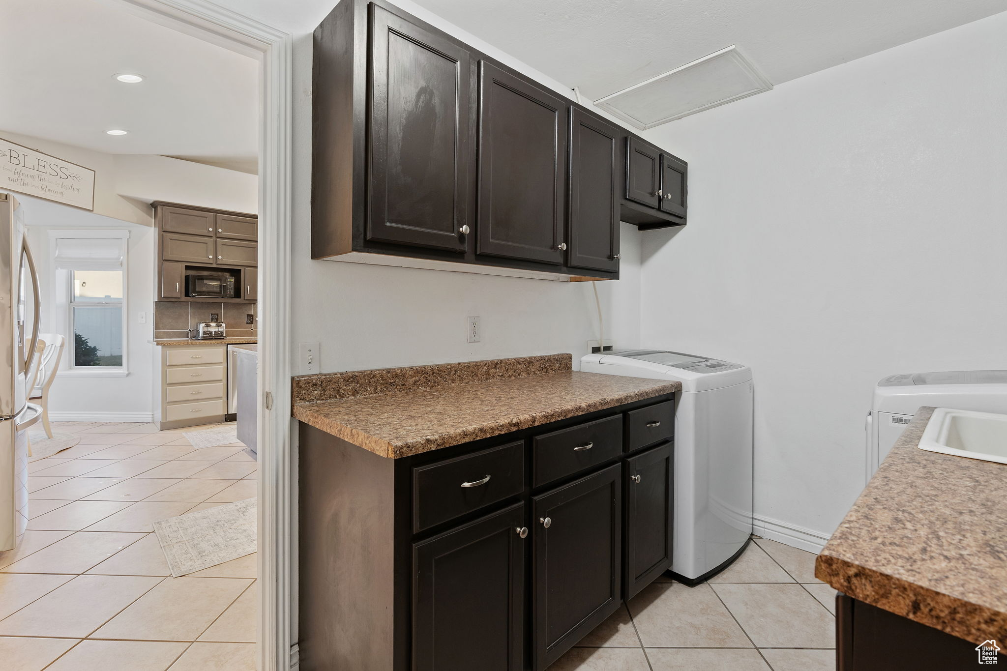 Laundry room, mud room, featuring cabinets and a sink.