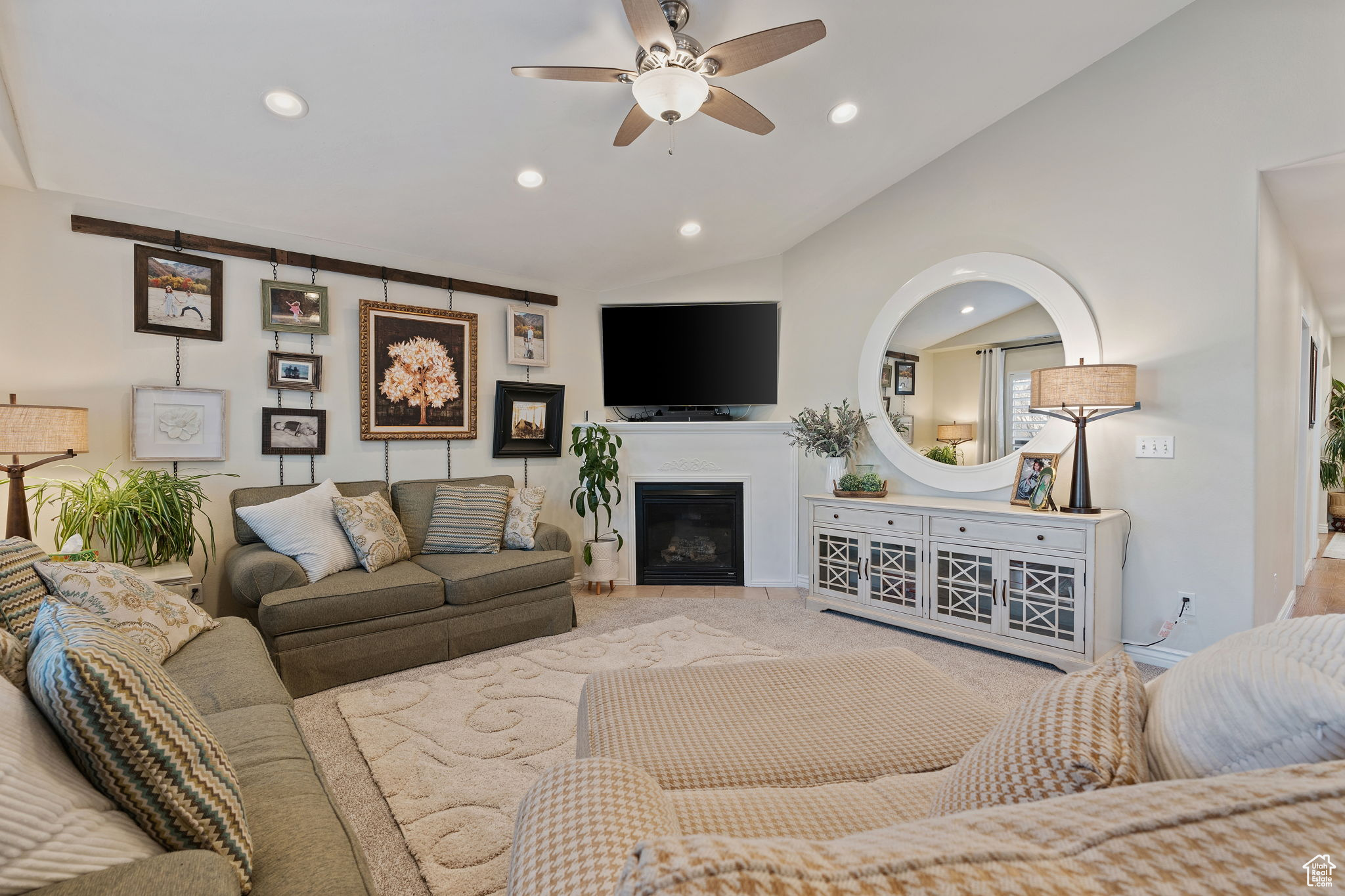 Family room featuring vaulted ceilings, can lighting, plantation shutters, gas fireplace and abundant natural light.