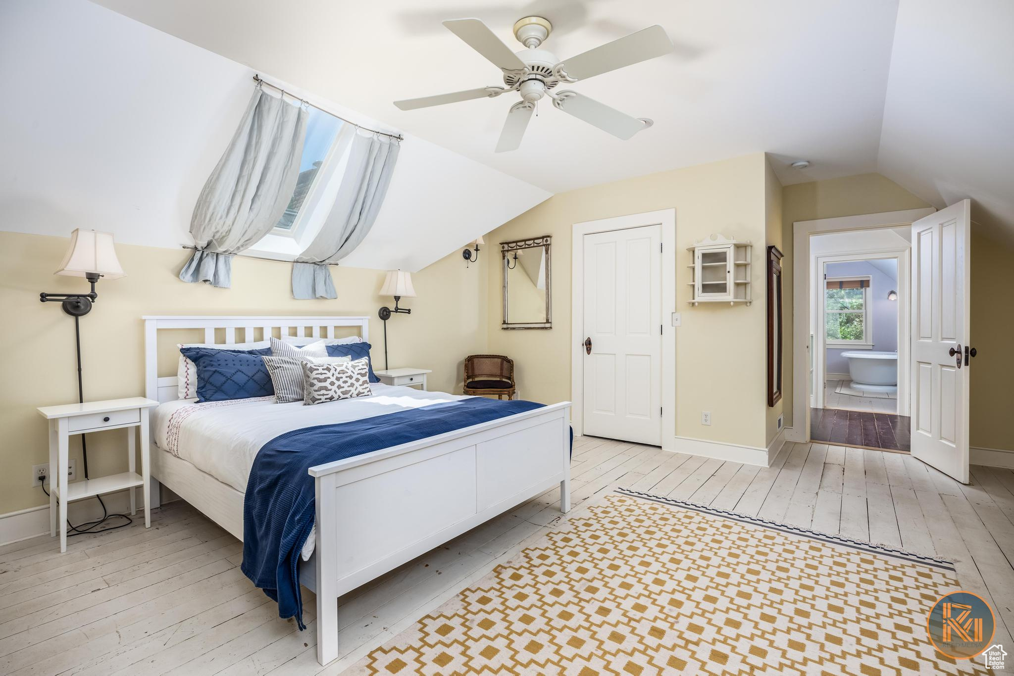 Bedroom featuring lofted ceiling, ceiling fan, light wood-type flooring, and baseboards