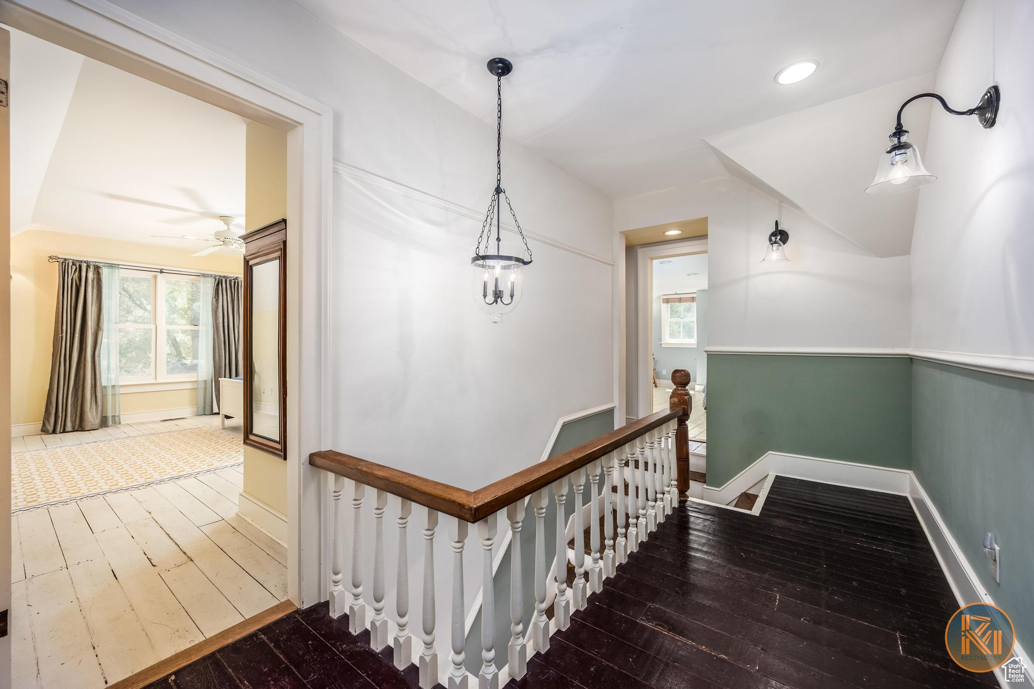 Hallway featuring hardwood / wood-style flooring, recessed lighting, an upstairs landing, and baseboards
