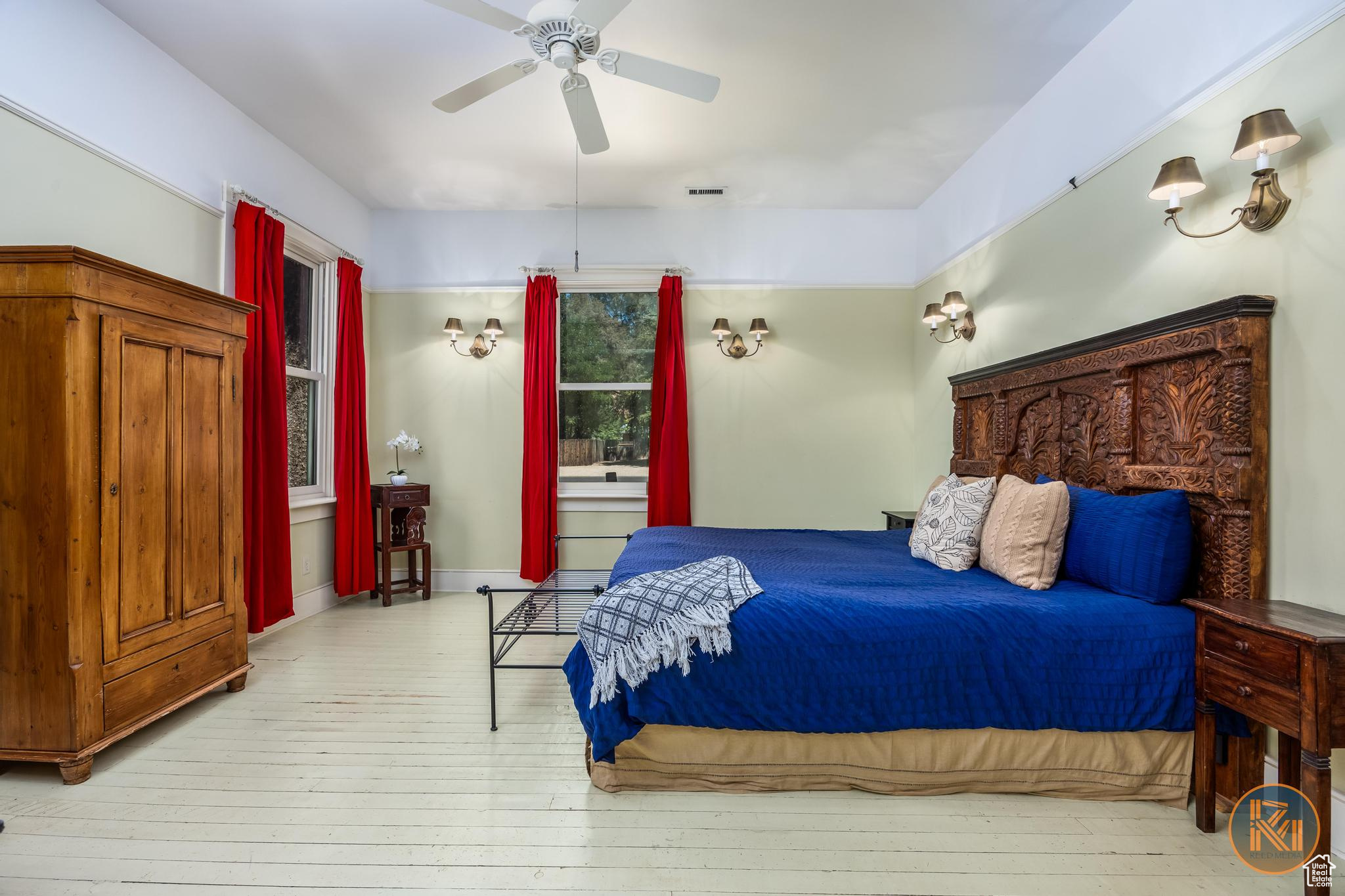 Bedroom with a ceiling fan and hardwood / wood-style floors