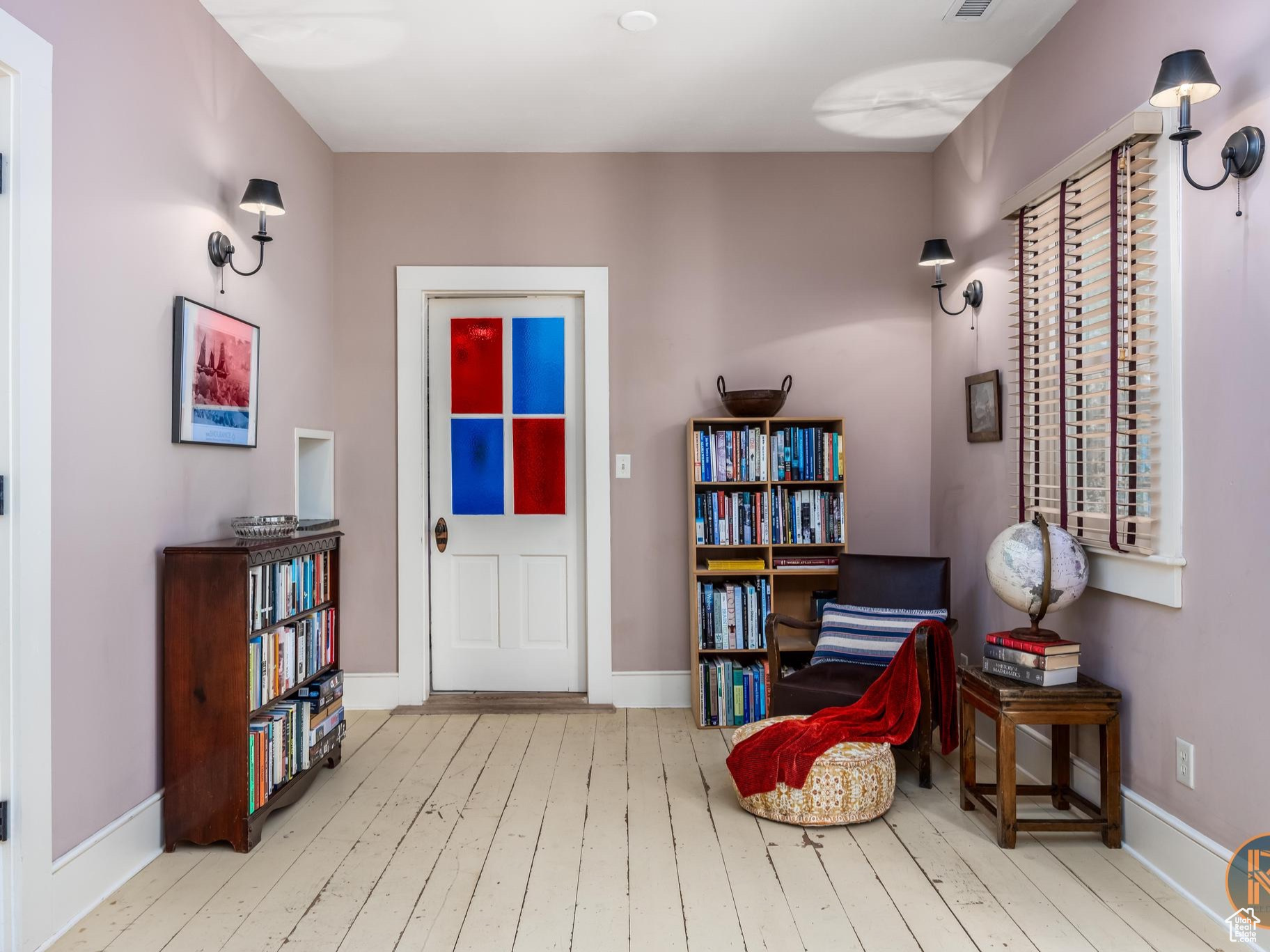 Living area with visible vents, hardwood / wood-style flooring, and baseboards