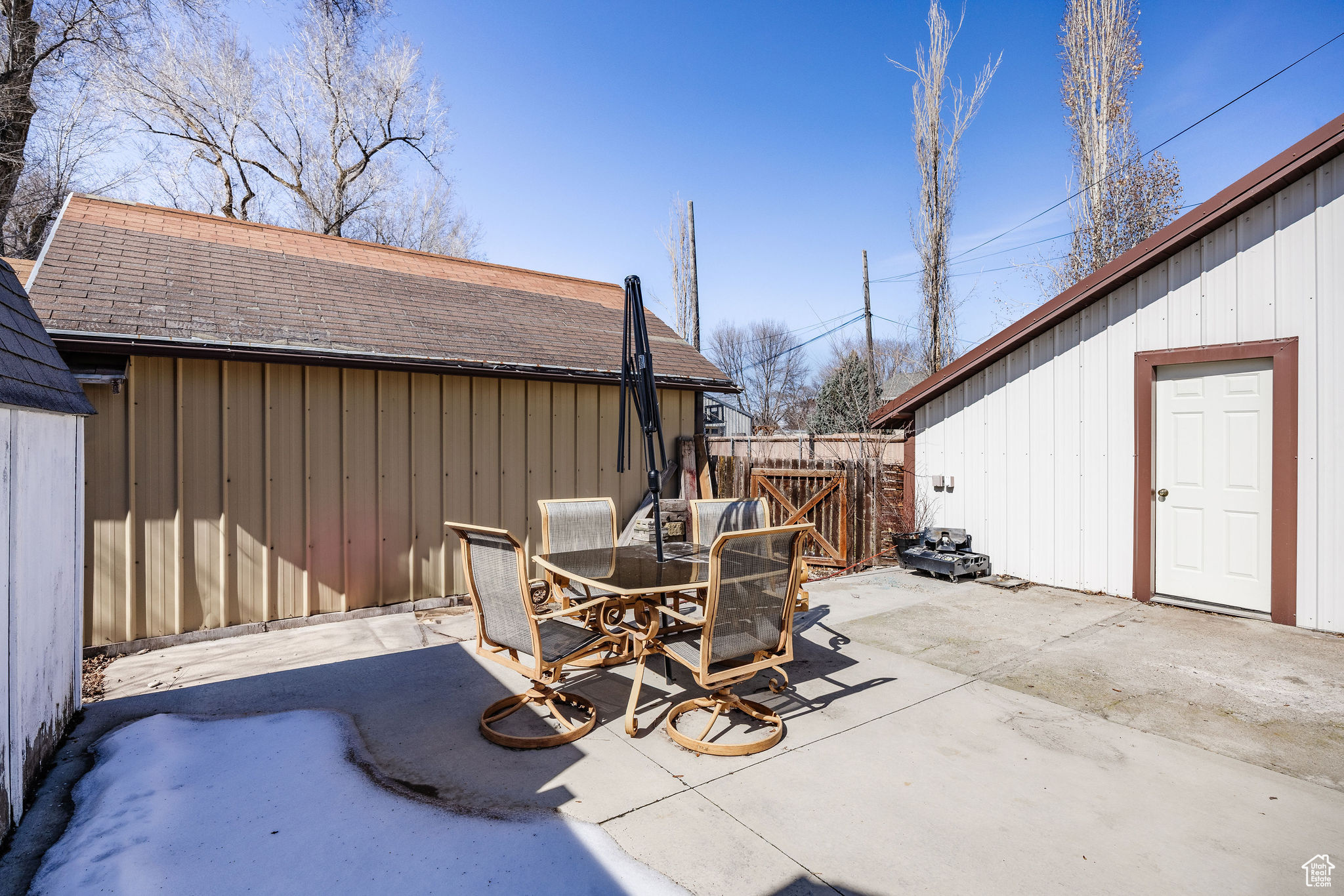 View of patio with outdoor dining space and fence