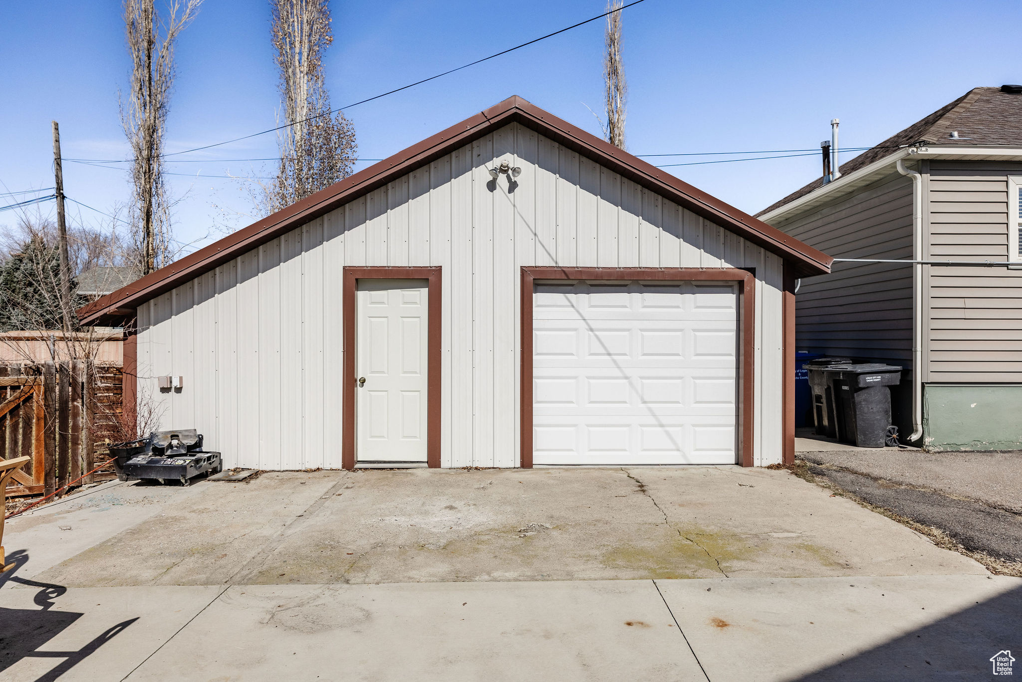 Detached garage featuring fence and driveway