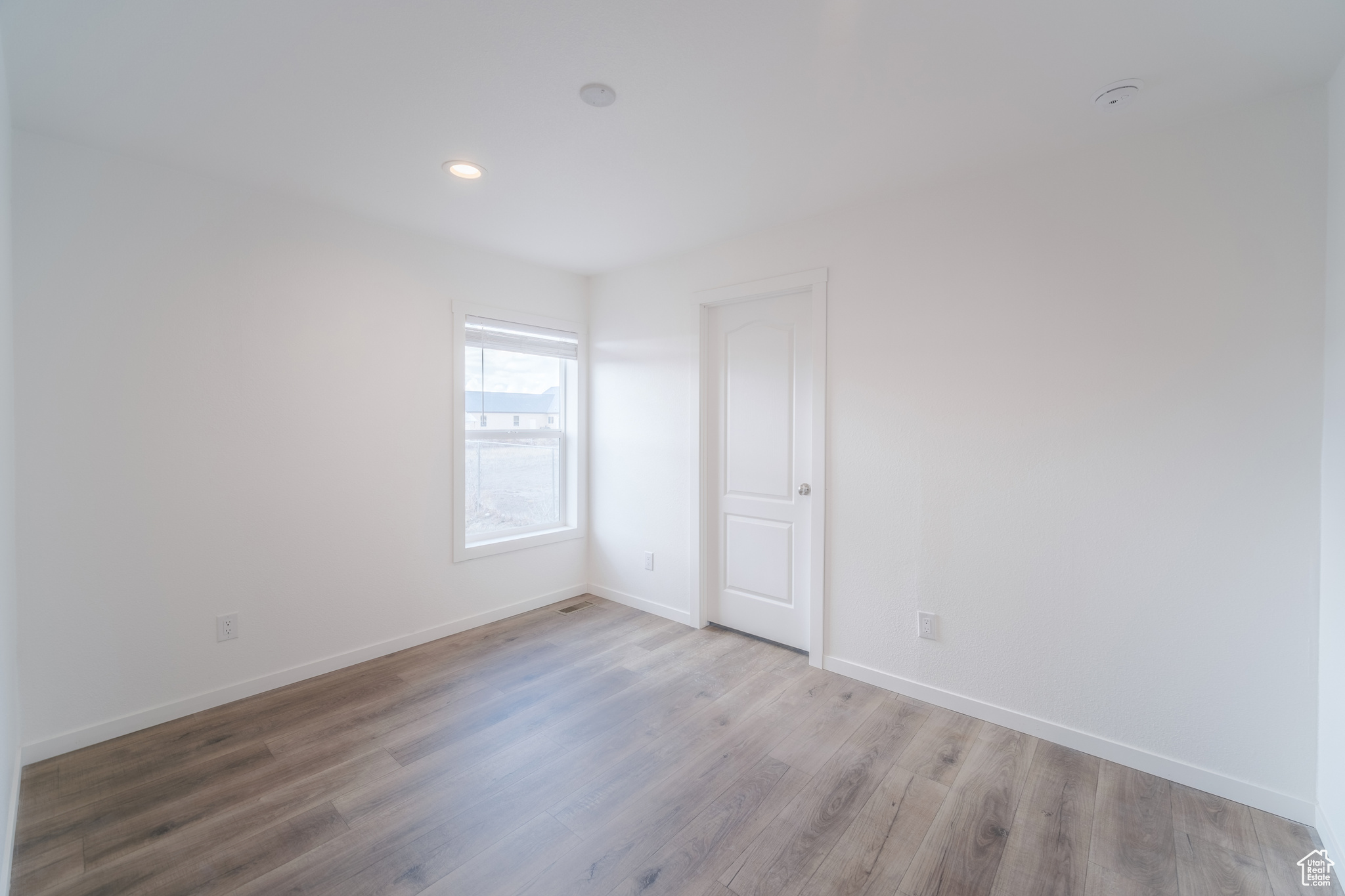 Unfurnished bedroom featuring recessed lighting, baseboards, and wood finished floors
