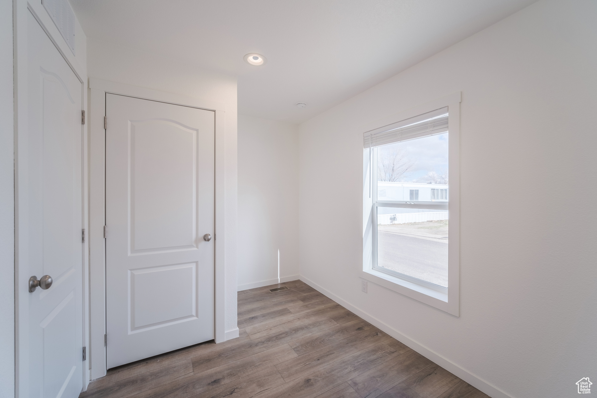 Empty room with recessed lighting, wood finished floors, and baseboards