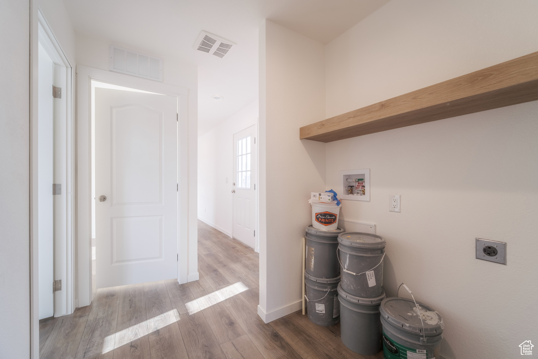 Laundry room featuring washer hookup, wood finished floors, visible vents, and hookup for an electric dryer