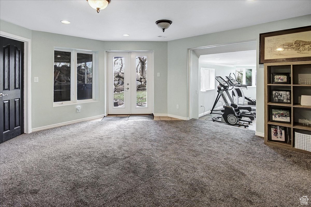Interior space with a wealth of natural light, recessed lighting, baseboards, and carpet floors
