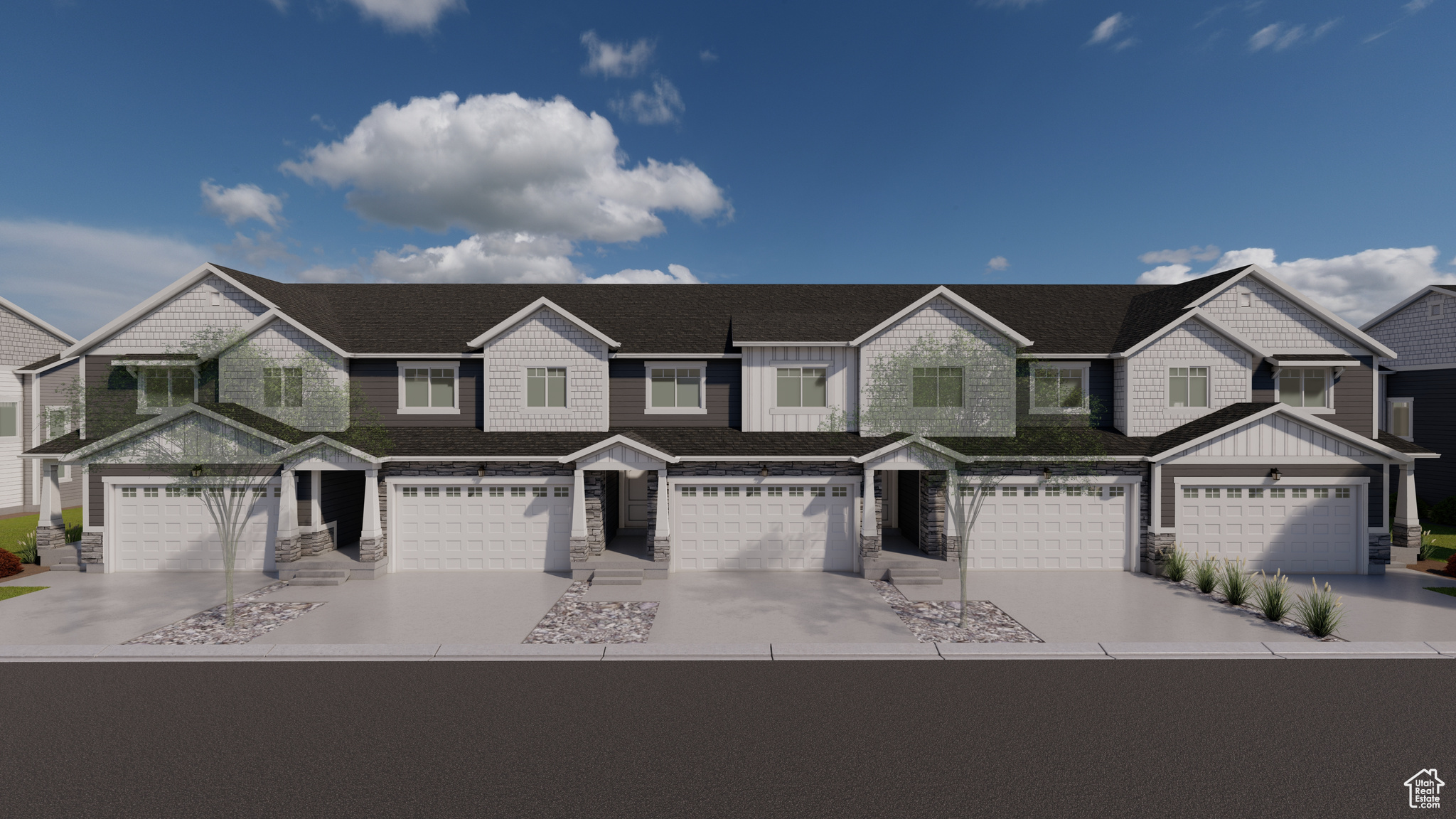 Townhome / multi-family property with stone siding, board and batten siding, and driveway