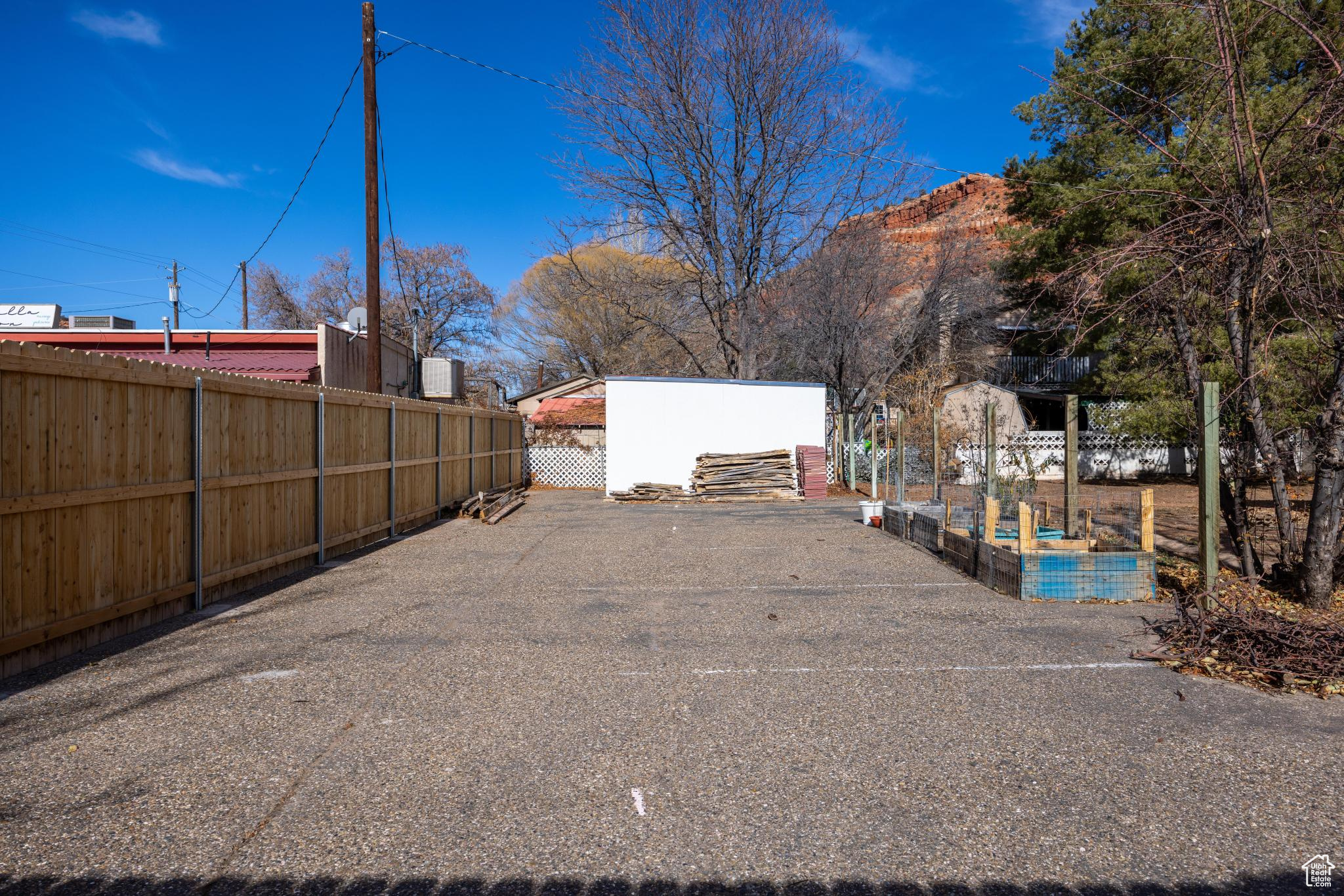 View of yard featuring a vegetable garden and fence