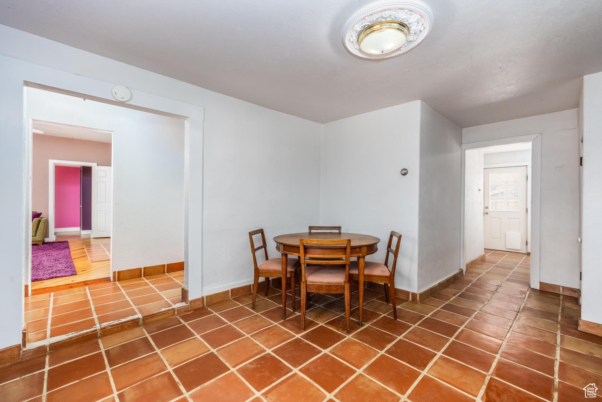 Dining space with tile patterned floors and baseboards