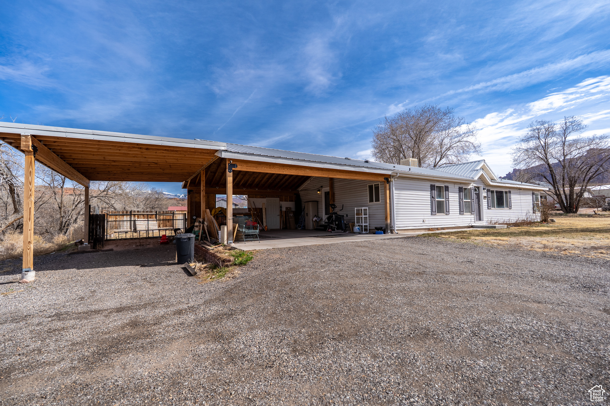 Exterior space with a carport and driveway