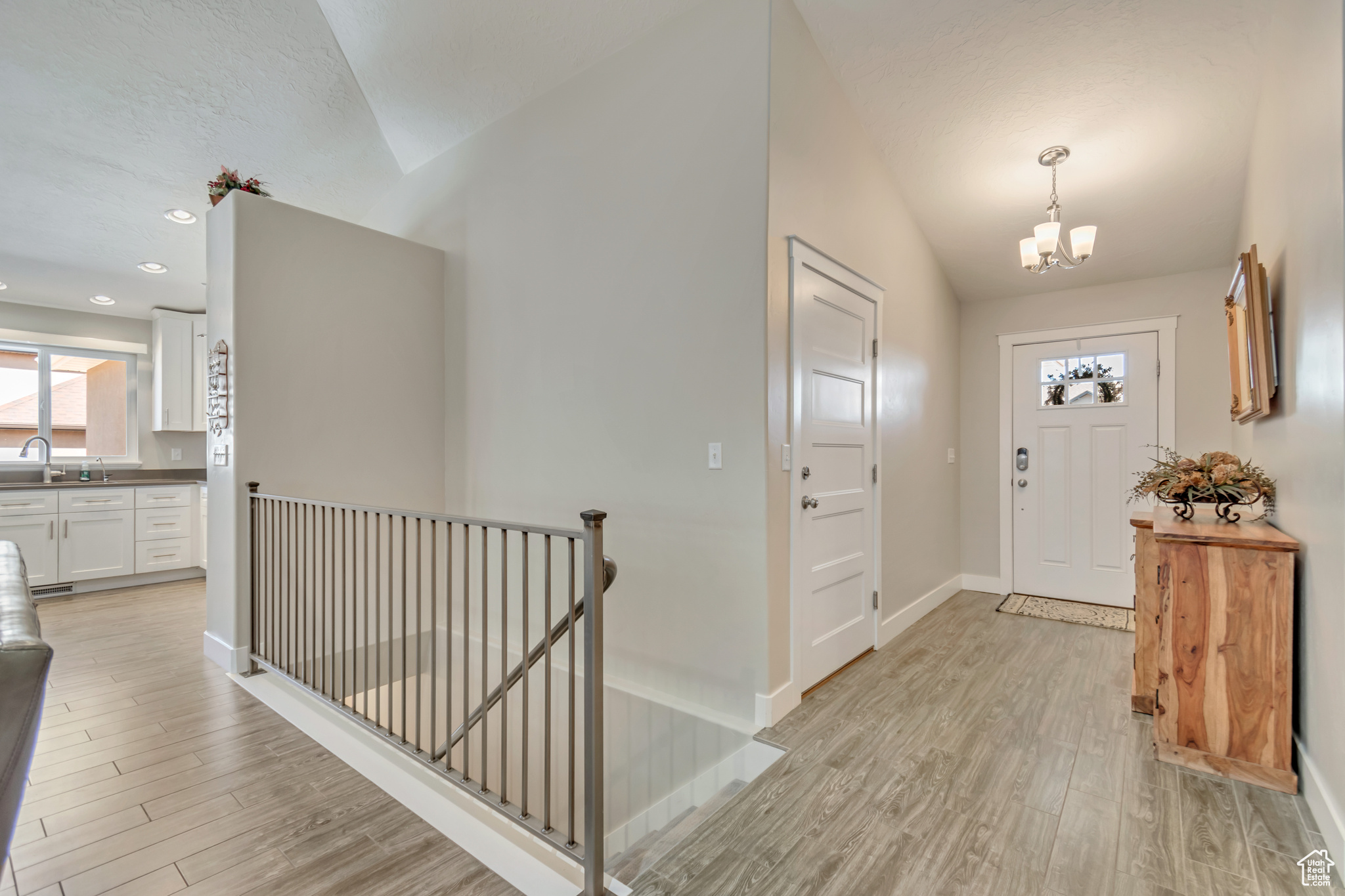 Foyer/entrance with chandelier and vaulted ceilings