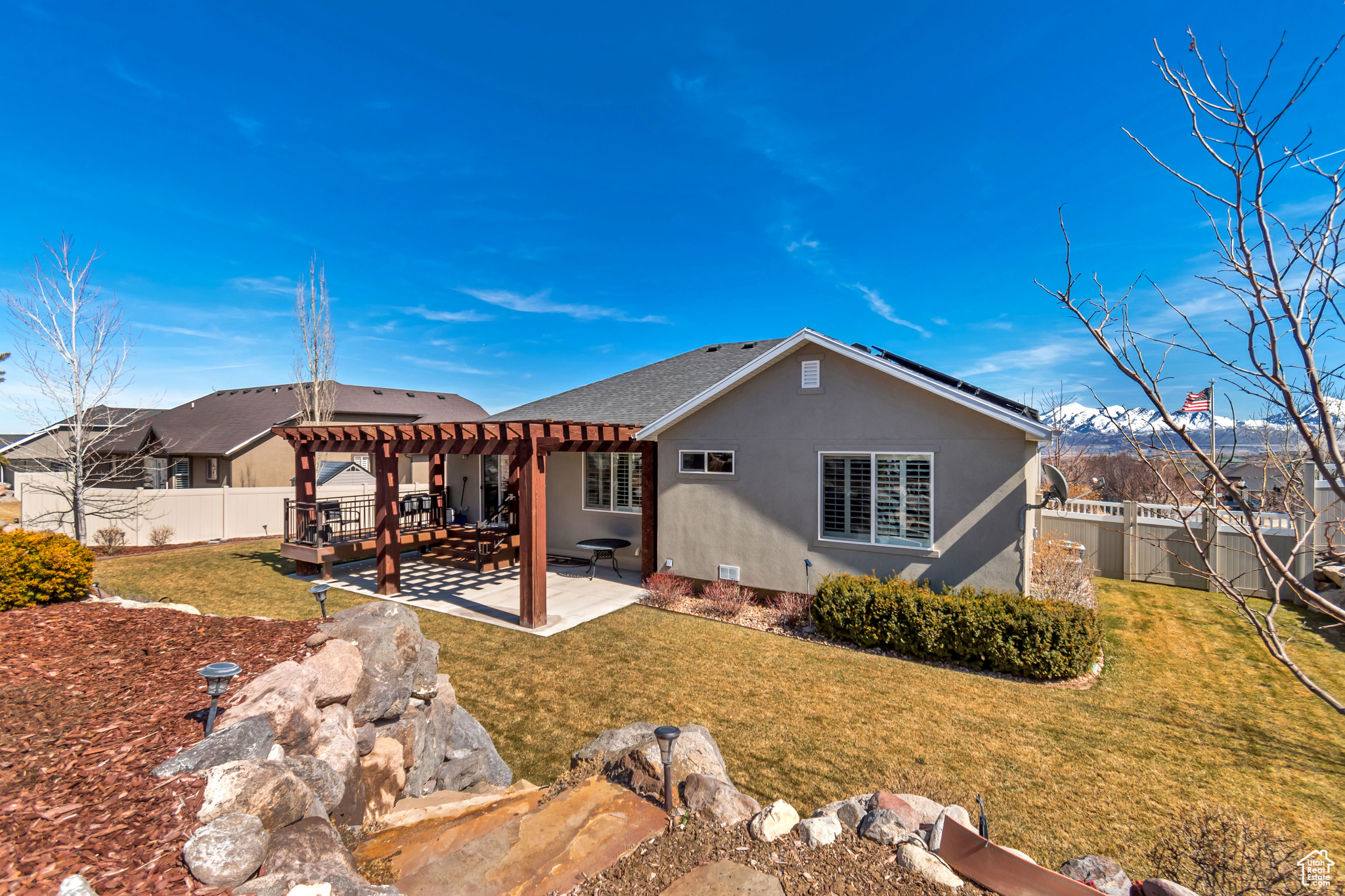 Back of house with a patio, a yard, a fenced backyard, a pergola, and stucco siding