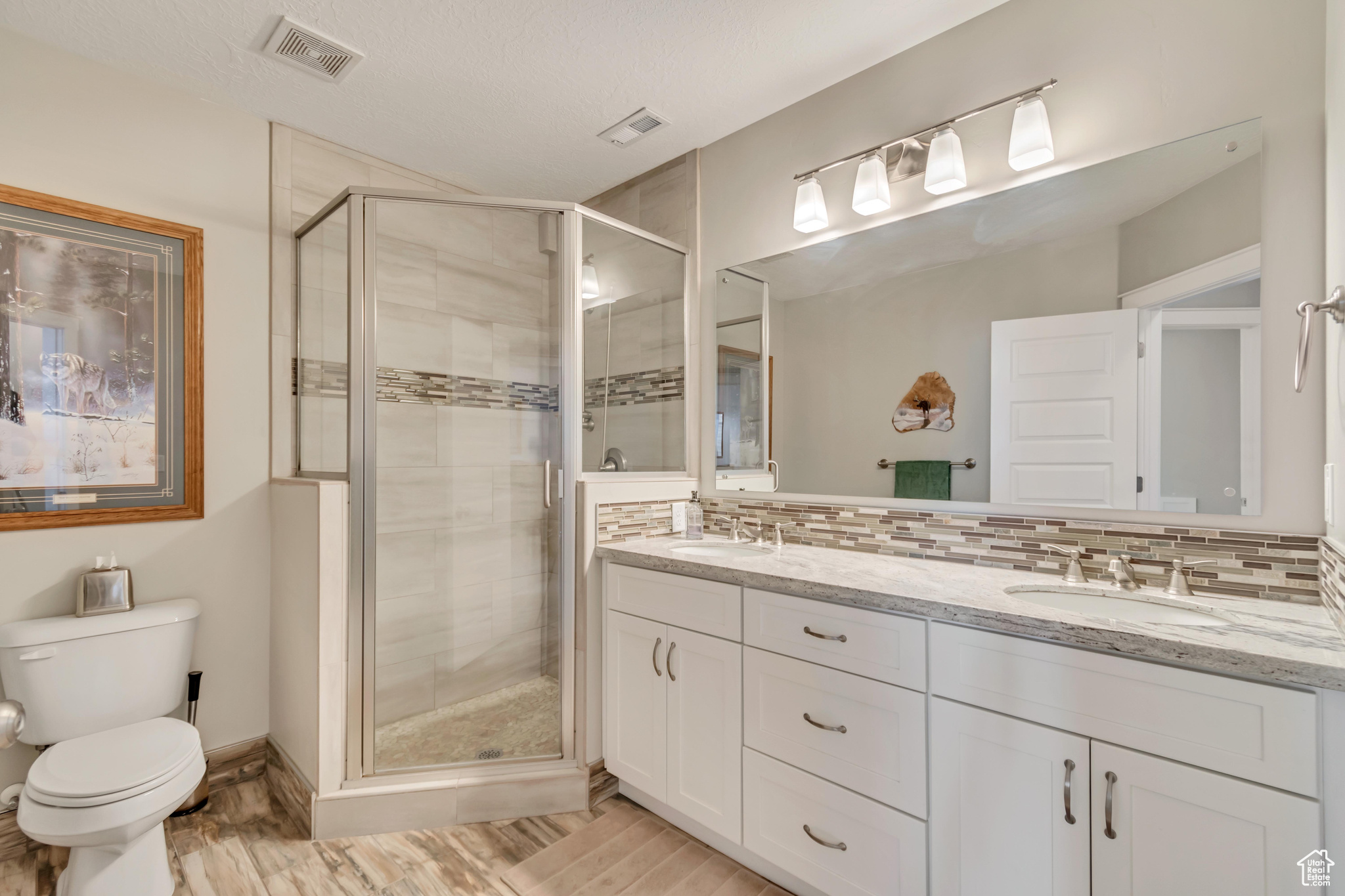 3/4 bathroom with custom tile and granite countertops