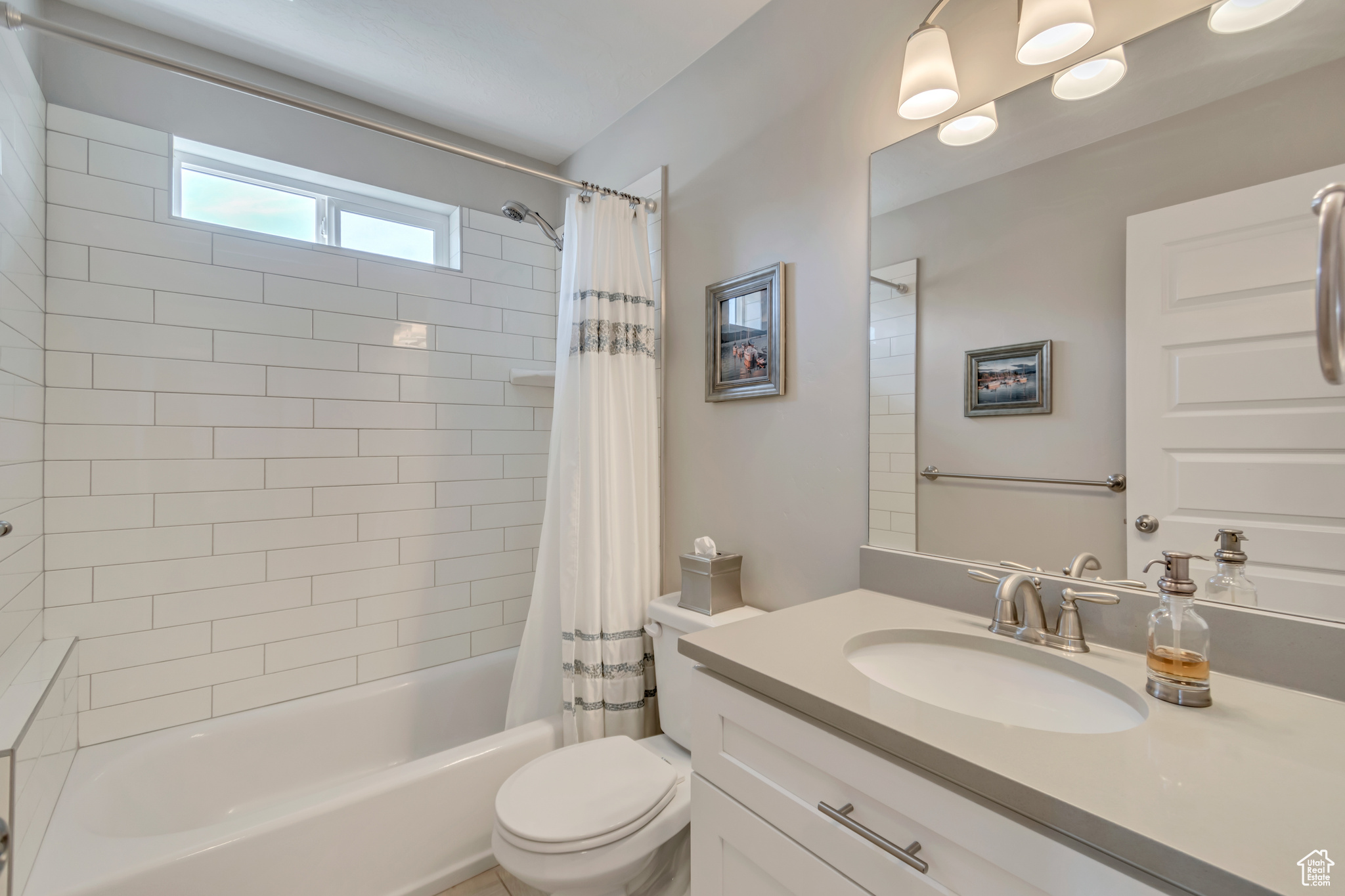 Full bath with vanity, toilet, and shower / tub combo