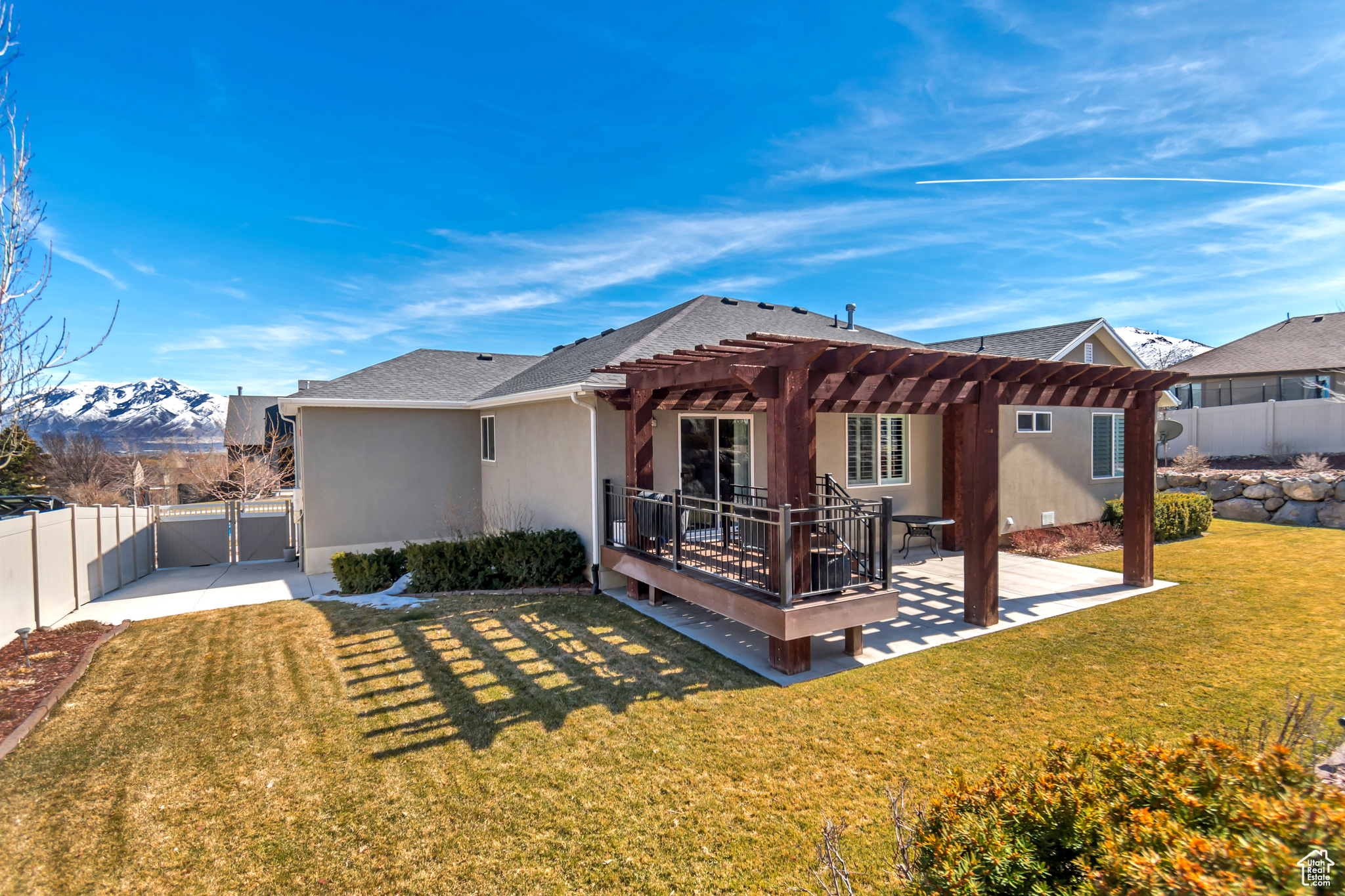 Rear view of house with a lawn, a pergola, a gate, RV parking, a fenced backyard, and a mountain view
