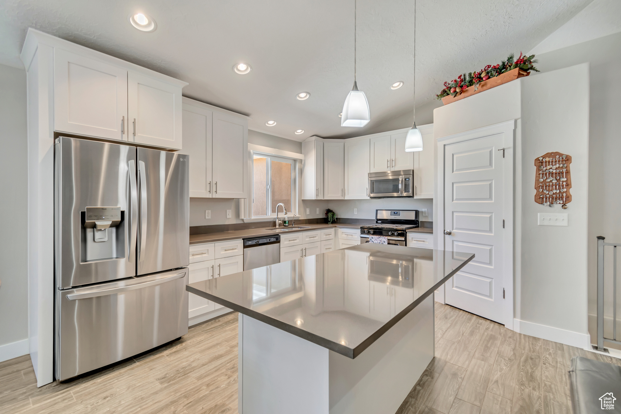 White craftsman style kitchen with quartz countertops and bar seating