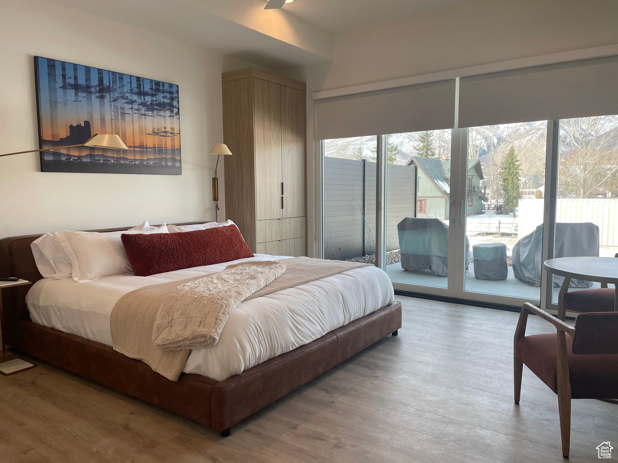 Bedroom with access to exterior and wood finished floors
