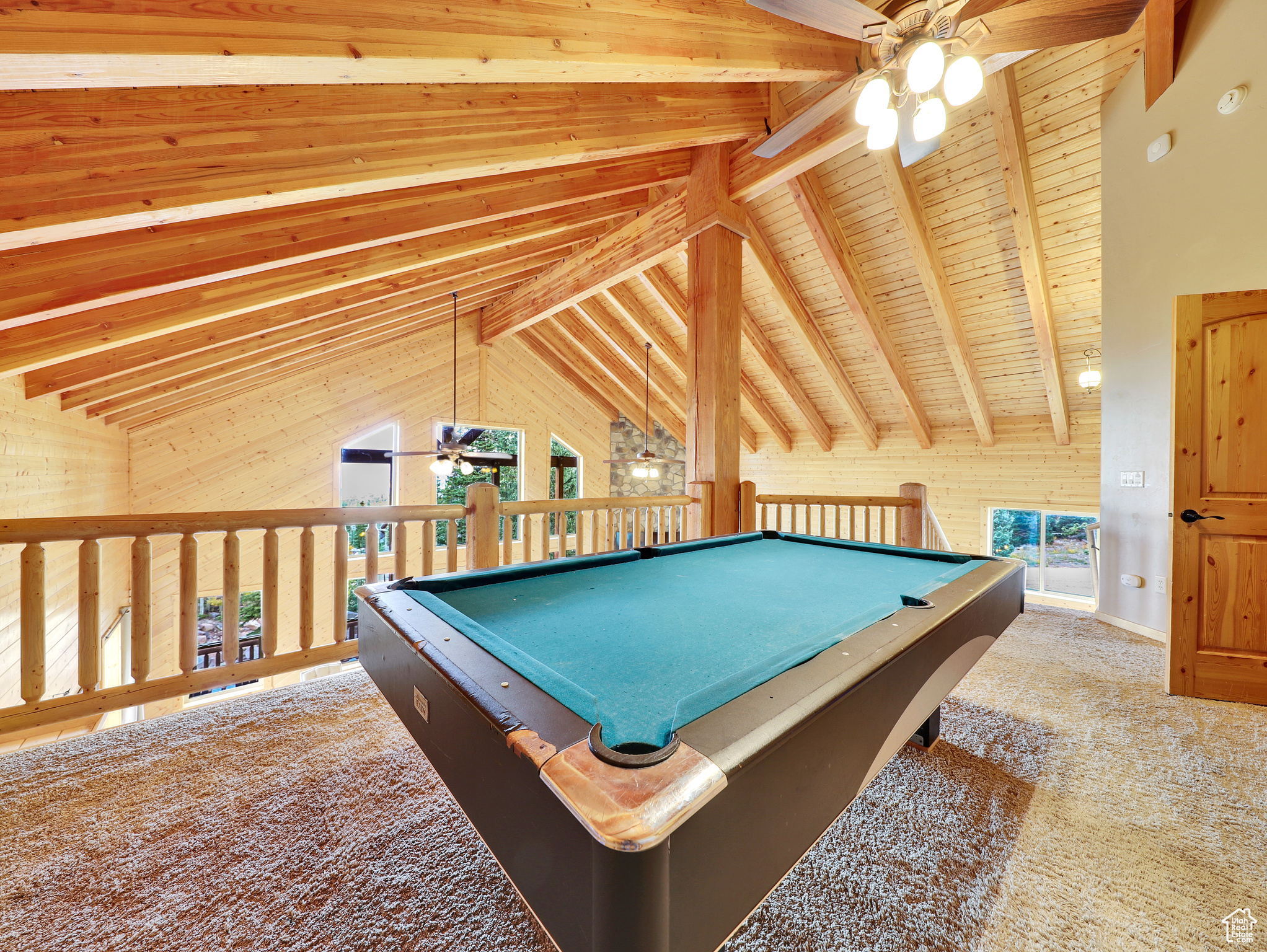 Rec room featuring billiards, wooden walls, carpet, ceiling fan, and vaulted ceiling with beams