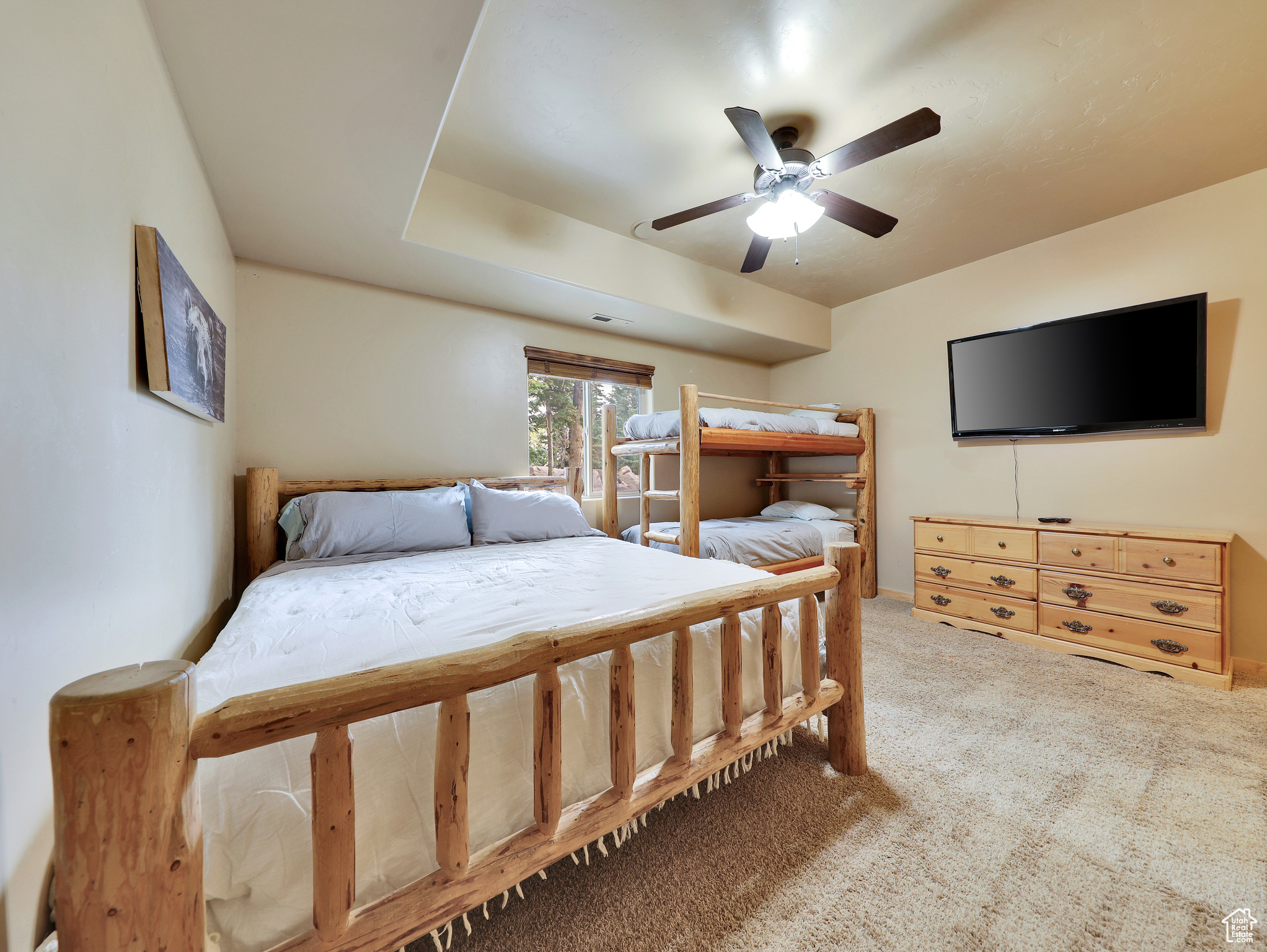 Bedroom featuring a ceiling fan and carpet floors