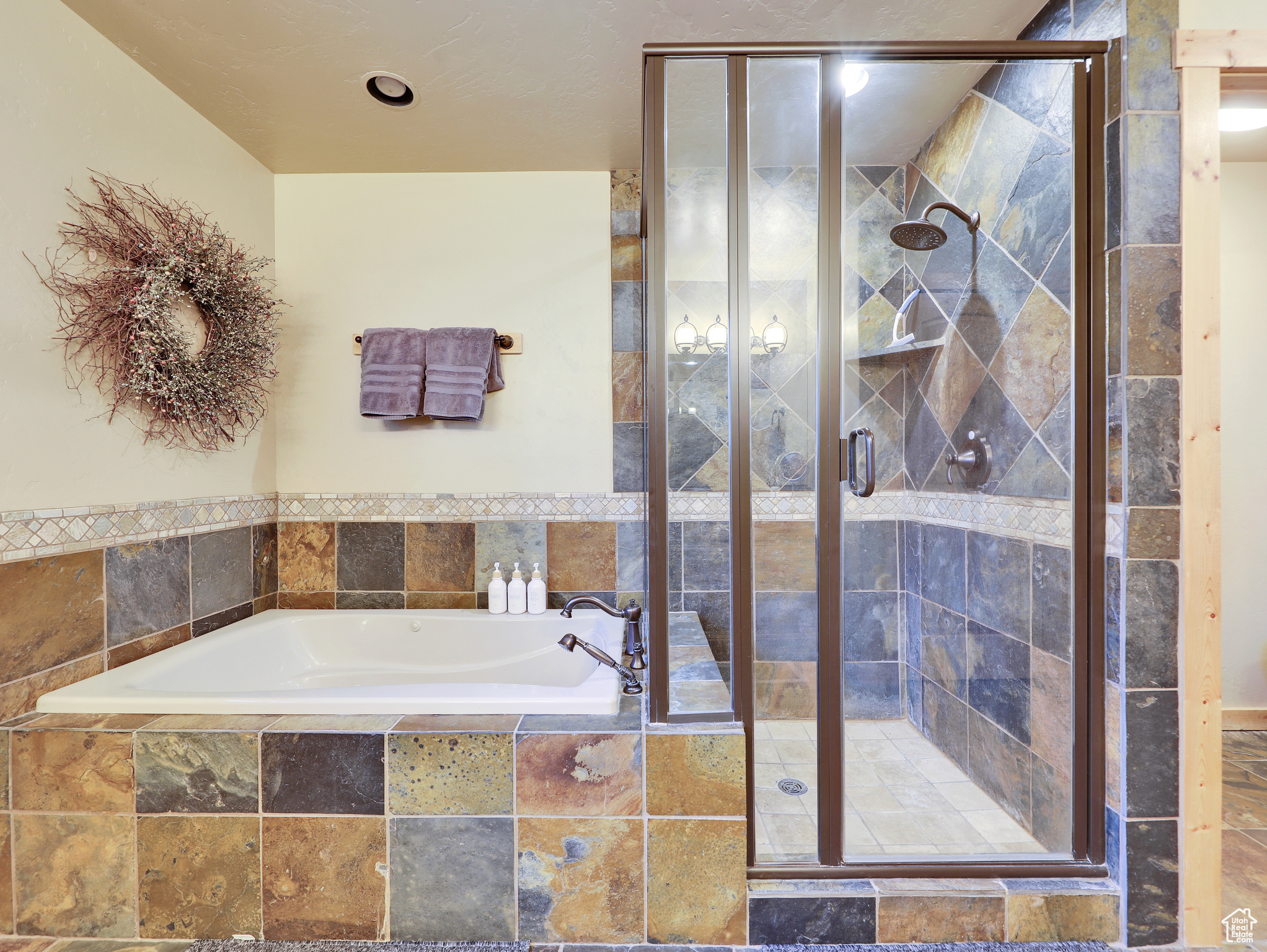 Full bath with a bath and a stall shower