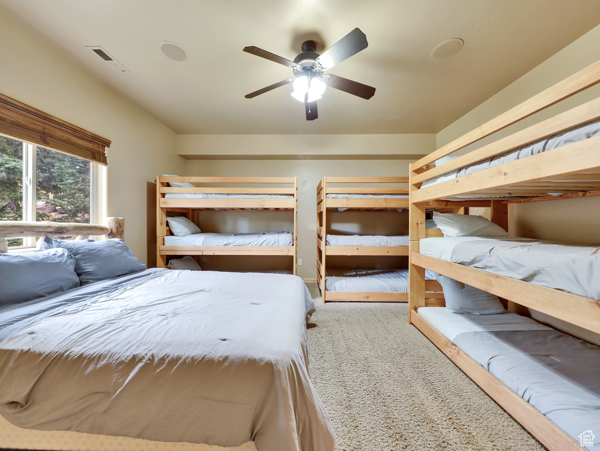 Unfurnished bedroom featuring visible vents, ceiling fan, and carpet floors