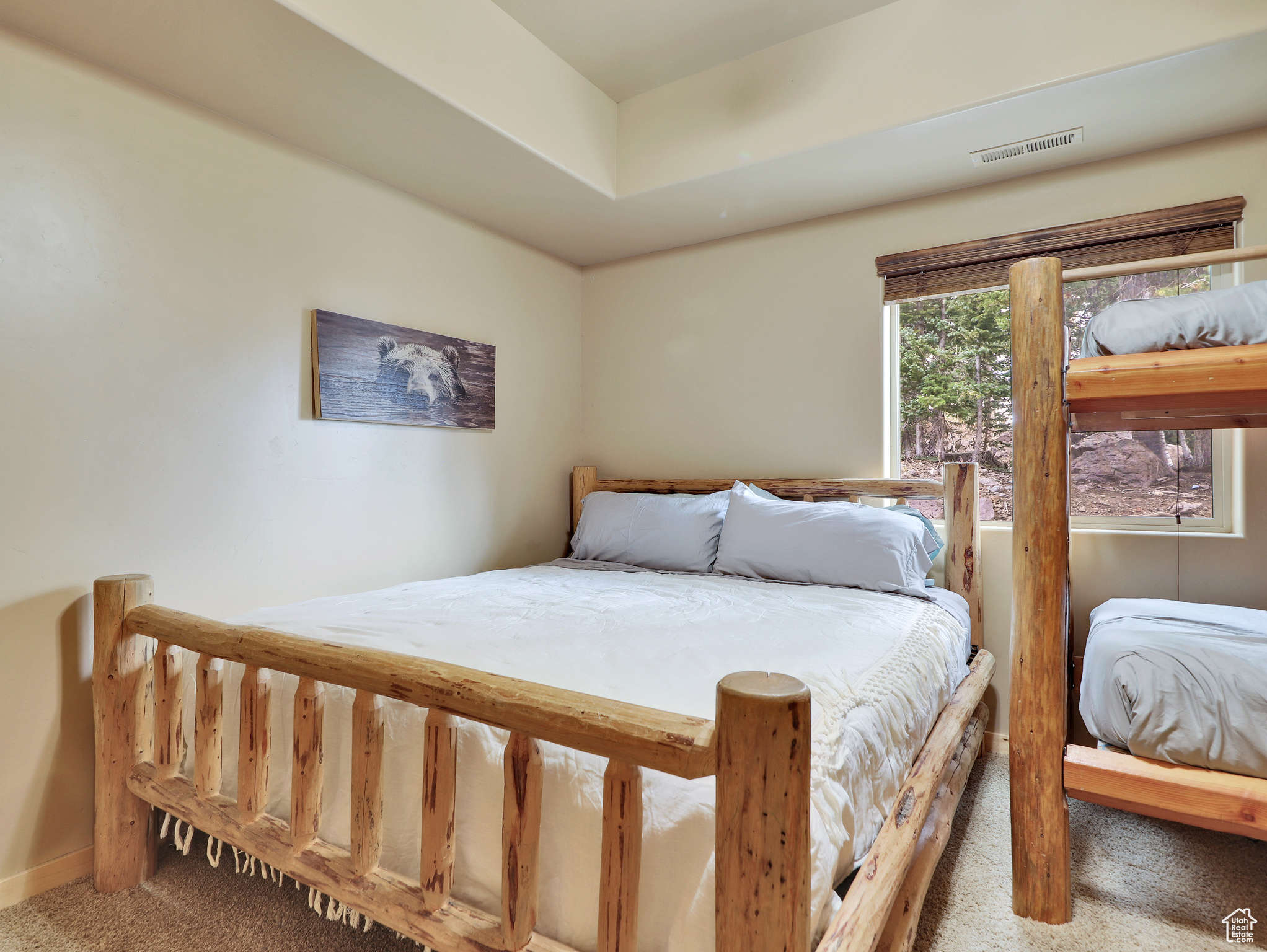 Carpeted bedroom with visible vents and baseboards