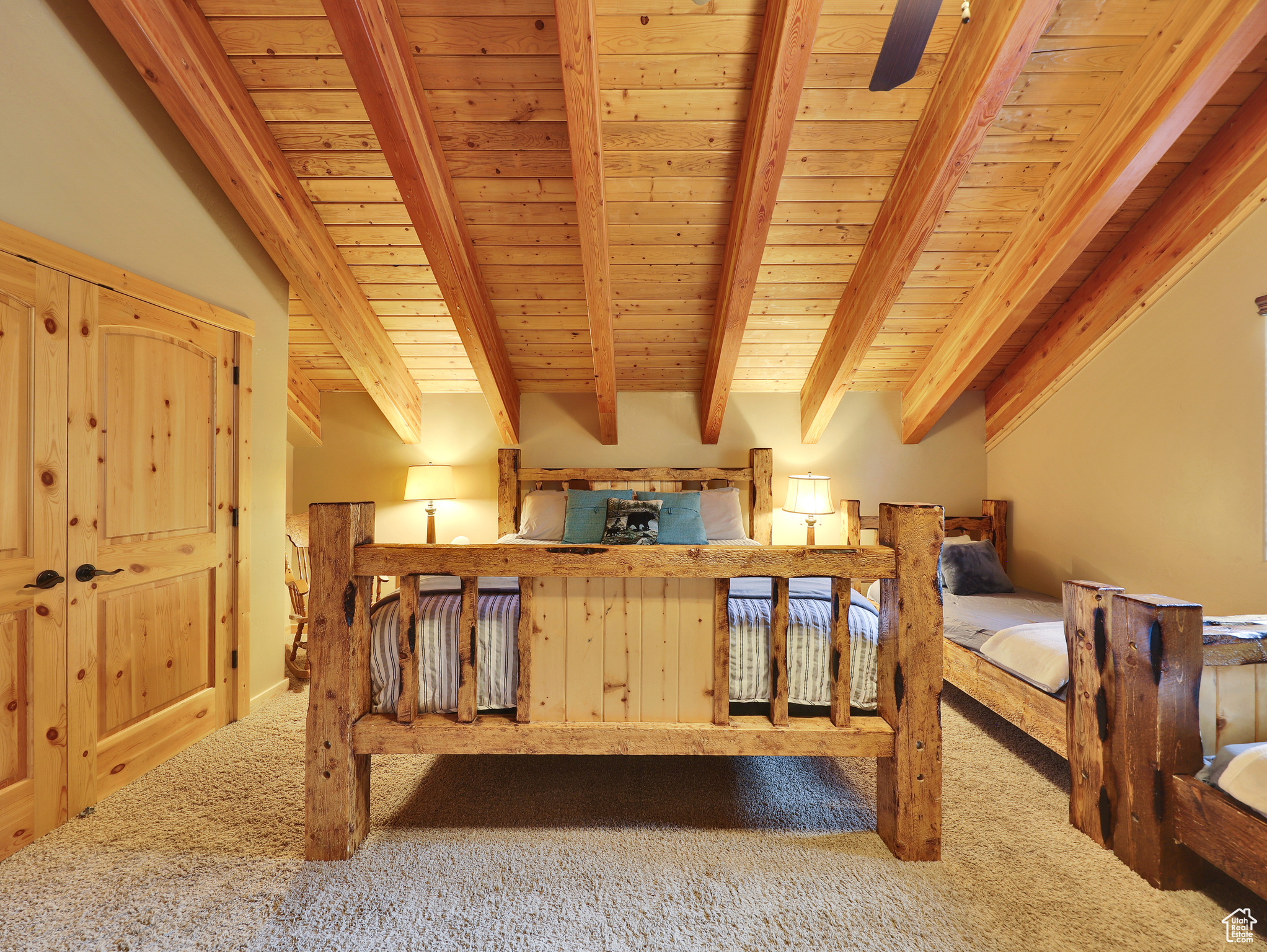 Bedroom featuring beam ceiling, carpet, and wooden ceiling